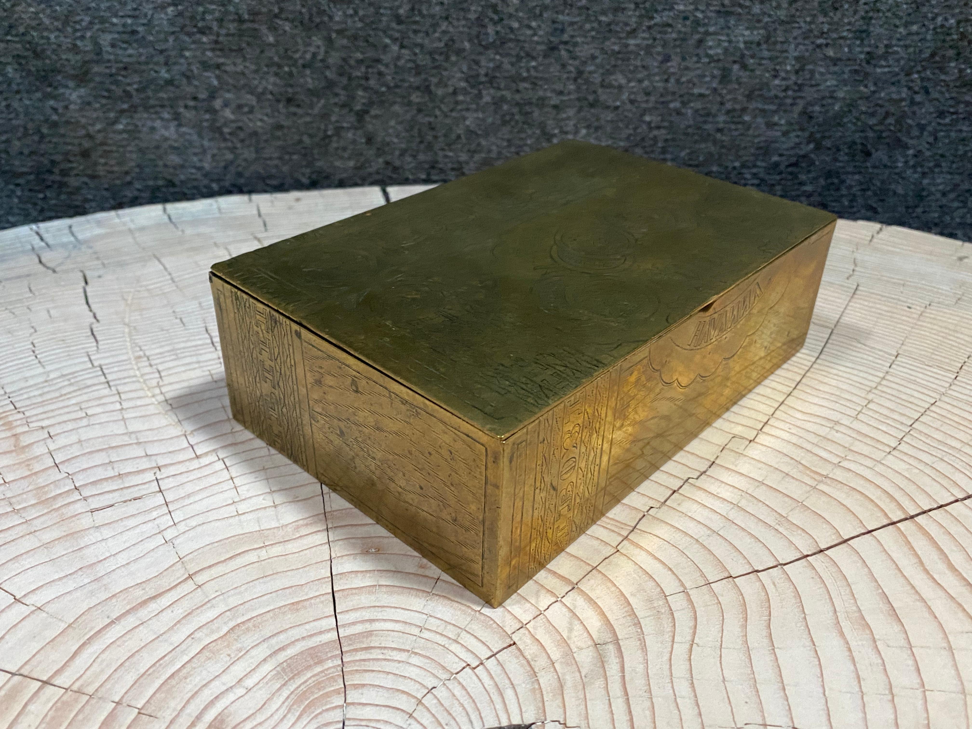 Brass Old Russia Engraved Cigarette Box
Made in Russia, its cover and sides are perfectly engraved to mimic wood and tobacco paper taxes.

The rich and the Tsars had these boxes of silver.
Ordinary people also wanted a piece of Luxury and they made