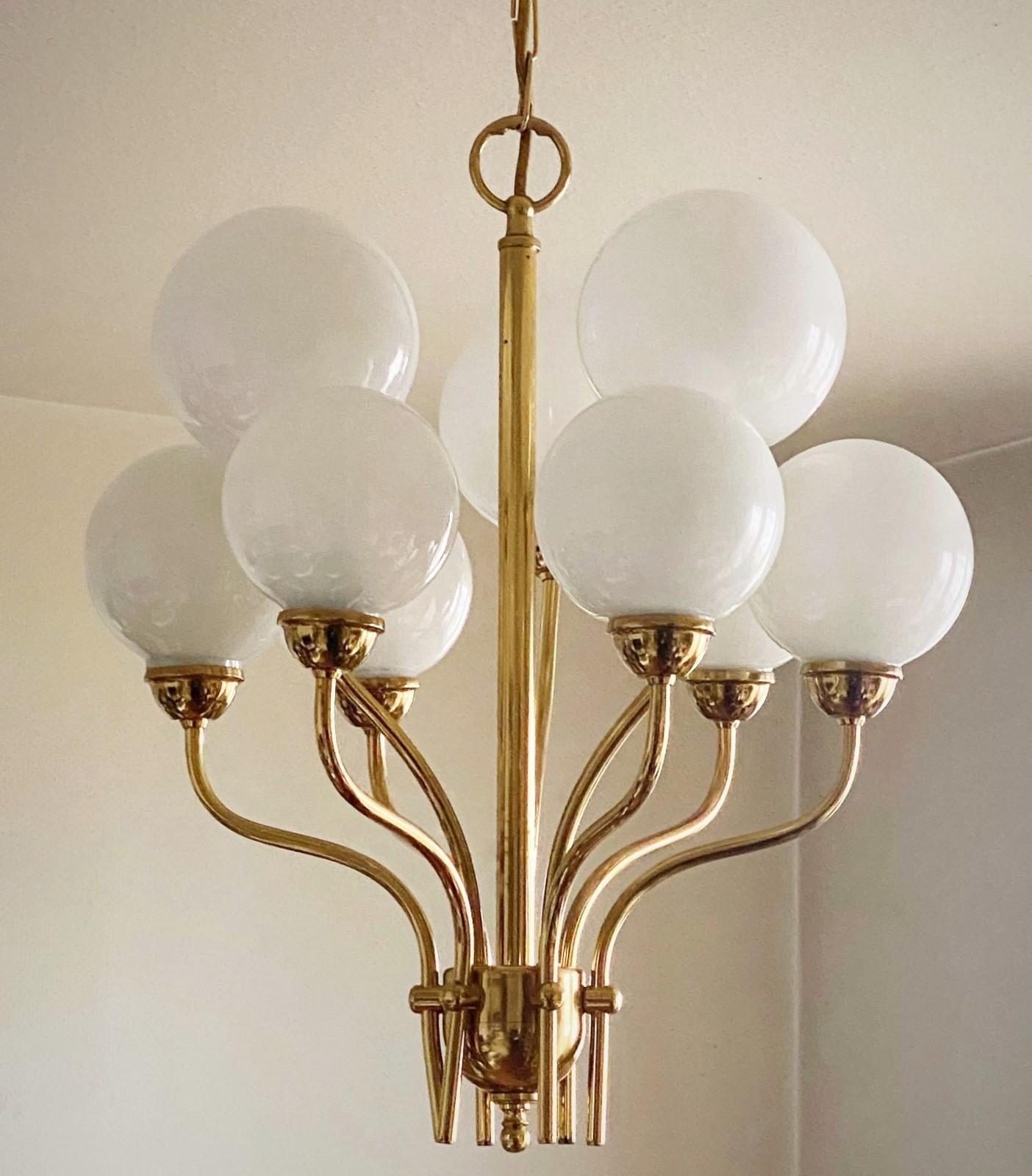 Beautiful gilt brass bouquet shaped ceiling lamp with nine-light arms in the Fontana Arte style, Italy, 1950s. Elegant design with nine opaline glass ball globes. Perfect for modern spaces giving your home warm and pleasant lighting. 
Nine-Light: