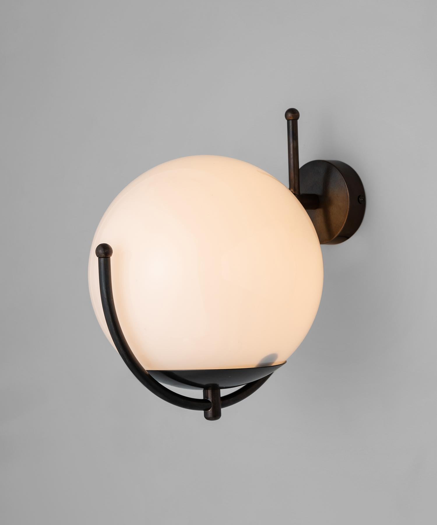 Hand patinated brass arm with opaline globe shade.

Made in Italy

Measures: 11.25