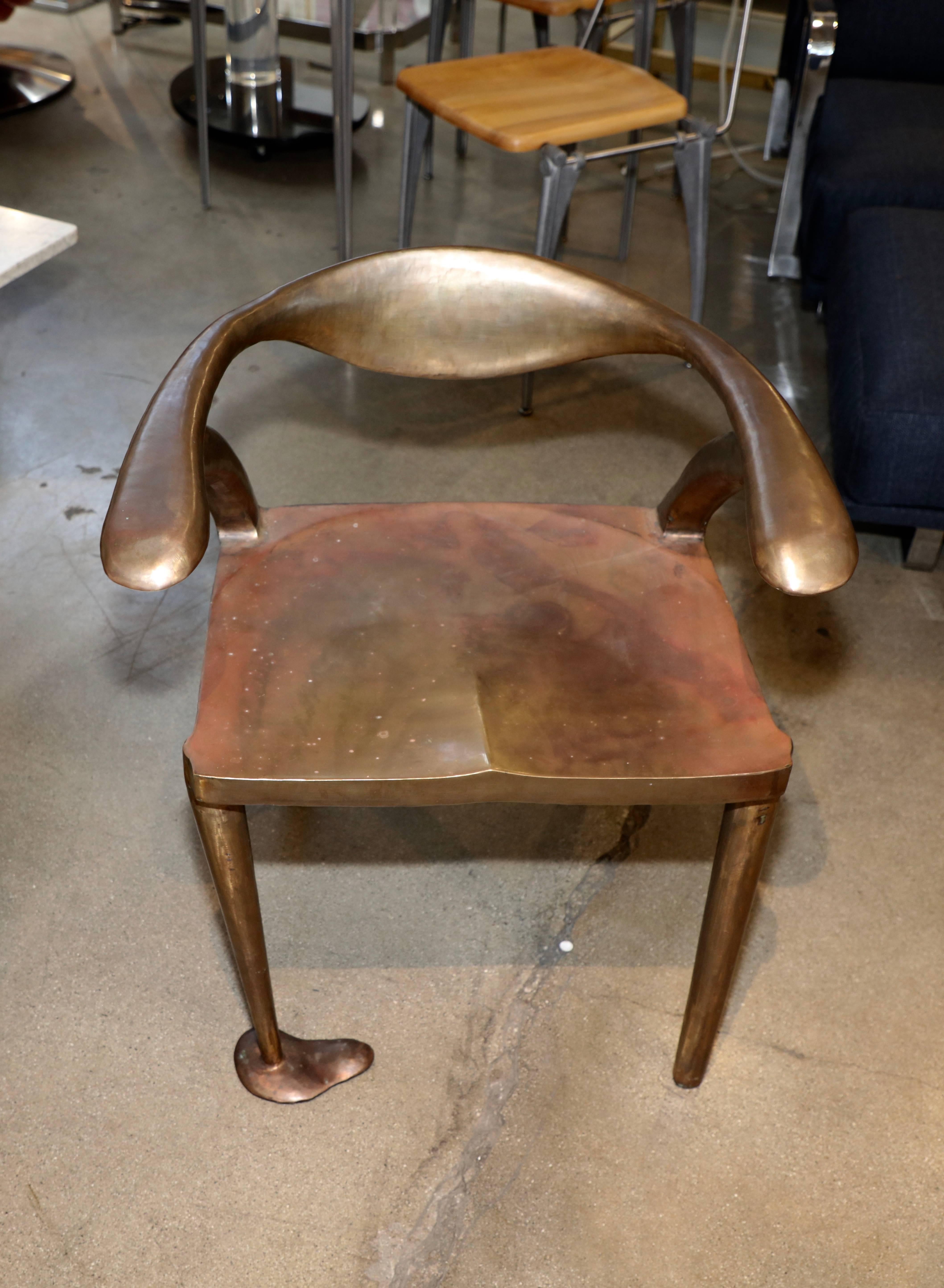 A really unique handmade chair in bronze or brass. It is not signed but is quite wonderfully made. There are seams where the metal has been welded, but the piece its well made and quite comfortable. There are marks and a crack on one leg which does