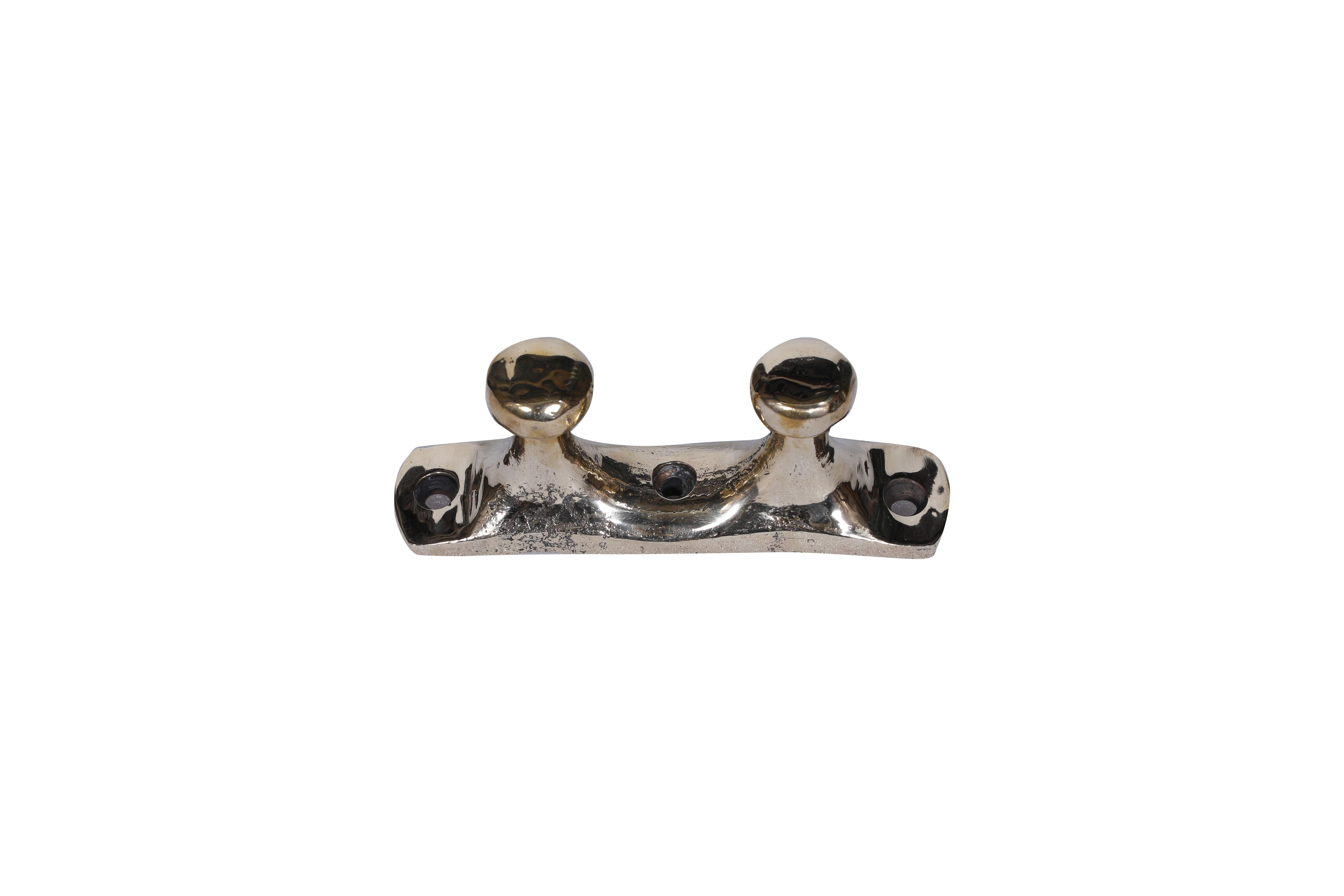Brass ship's cleats from a decommissioned ship.  Polished but with traces of the original patina.  If not using them on your own yacht, or an a fabulous office paperweight or artifact, if you mount them on the wall, they make a great towel rack or