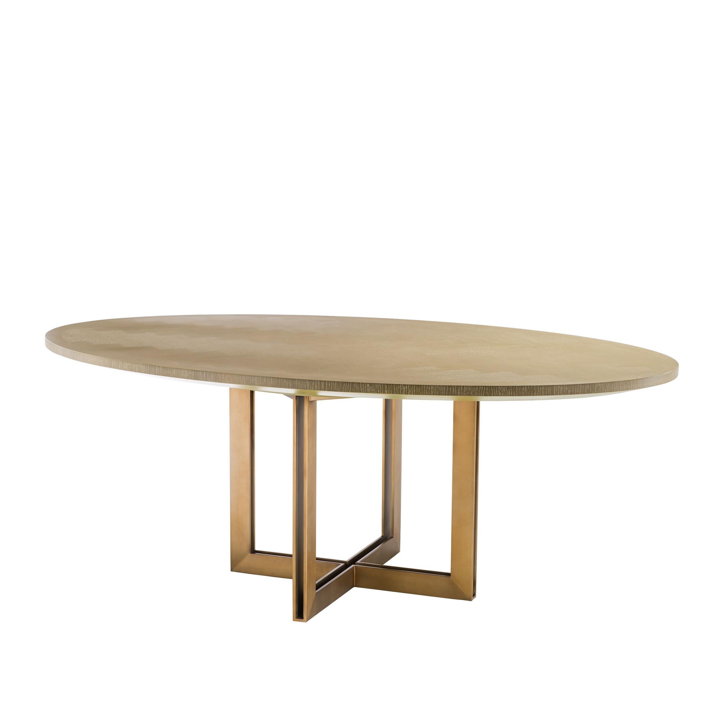 Dining table brass oval with charcoal oak
veneer top. On bronze finish base.
Also available in brass oval black dining table.