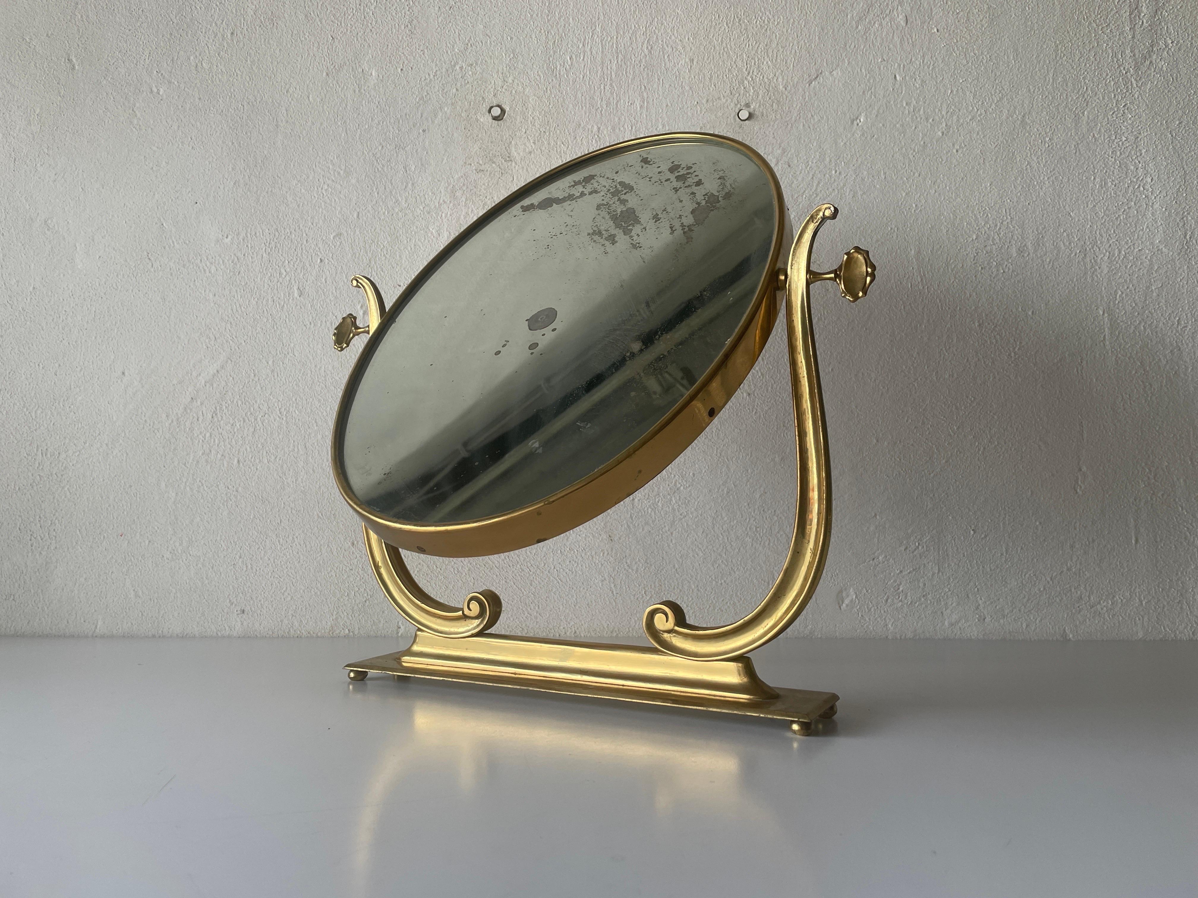 Brass Oval Frame Vanity Table Mirror, 1960s, Italy

It is very ideal and suitable for all living areas.

No damage, no crack.
Wear consistent with age and use.

Measurements: 
Height: 49 cm
Width: 45 cm
Oval Mirror: 43 cm x 32 cm
Base: 37 cm x 7 cm