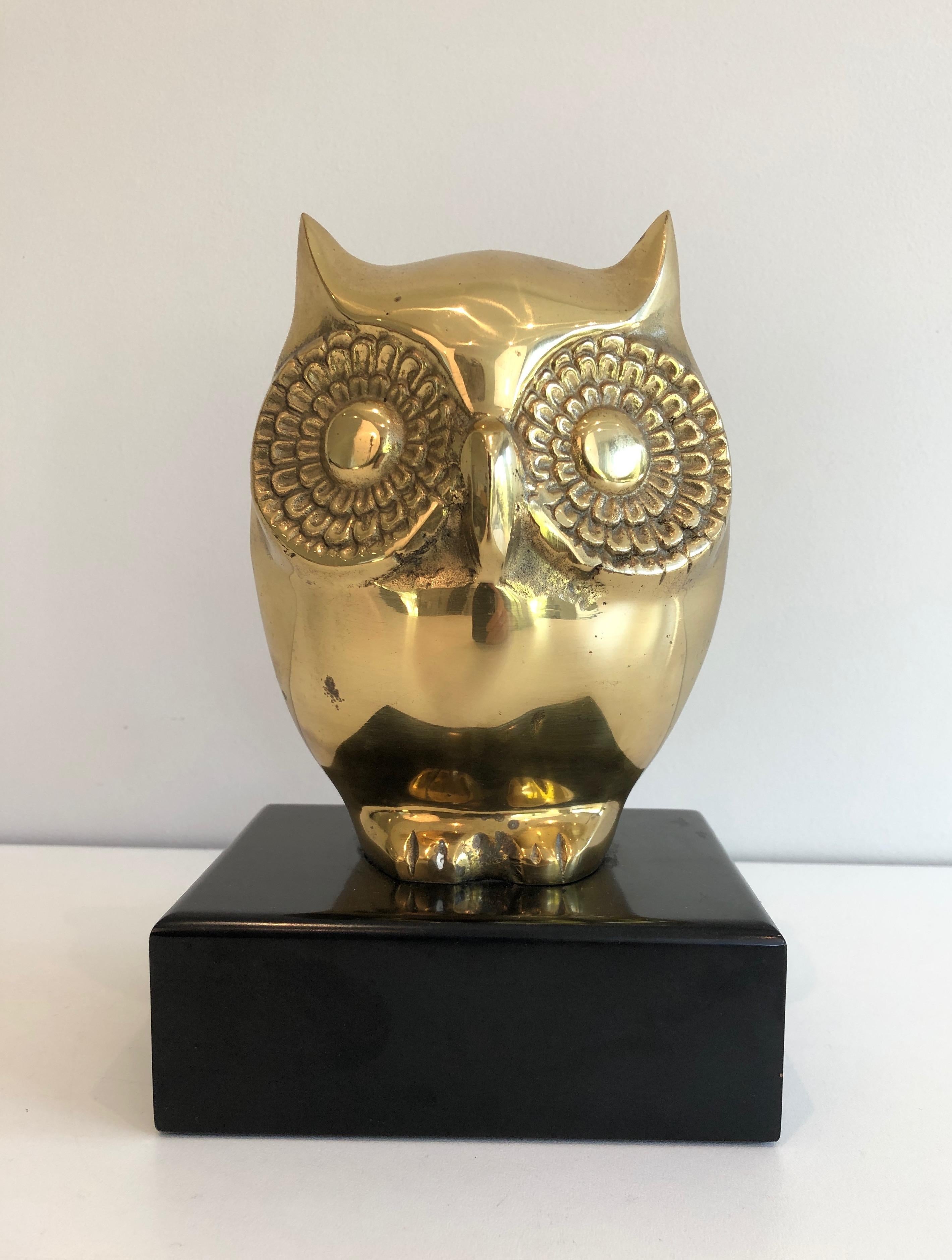 This decorative and fine owl is made of brass on a black lacquered wooden Stand. This is a French work, circa 1970.