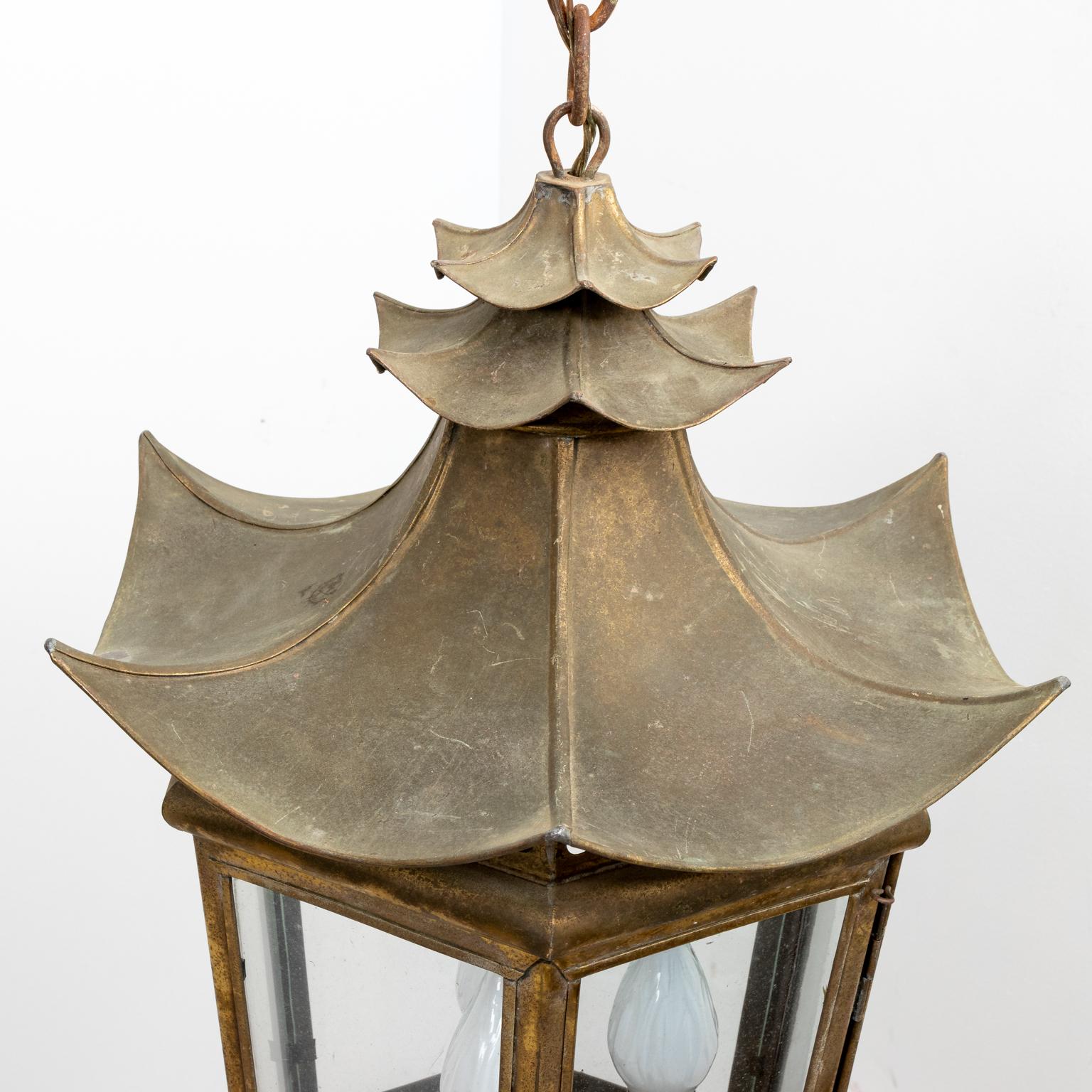 Brass pagoda shaped three light ceiling fixture with six glass pans and open fretwork top, circa 1960s. Please note of wear consistent with age including distressed finish. The piece also has minor fading, oxidation, patina, and discoloration to