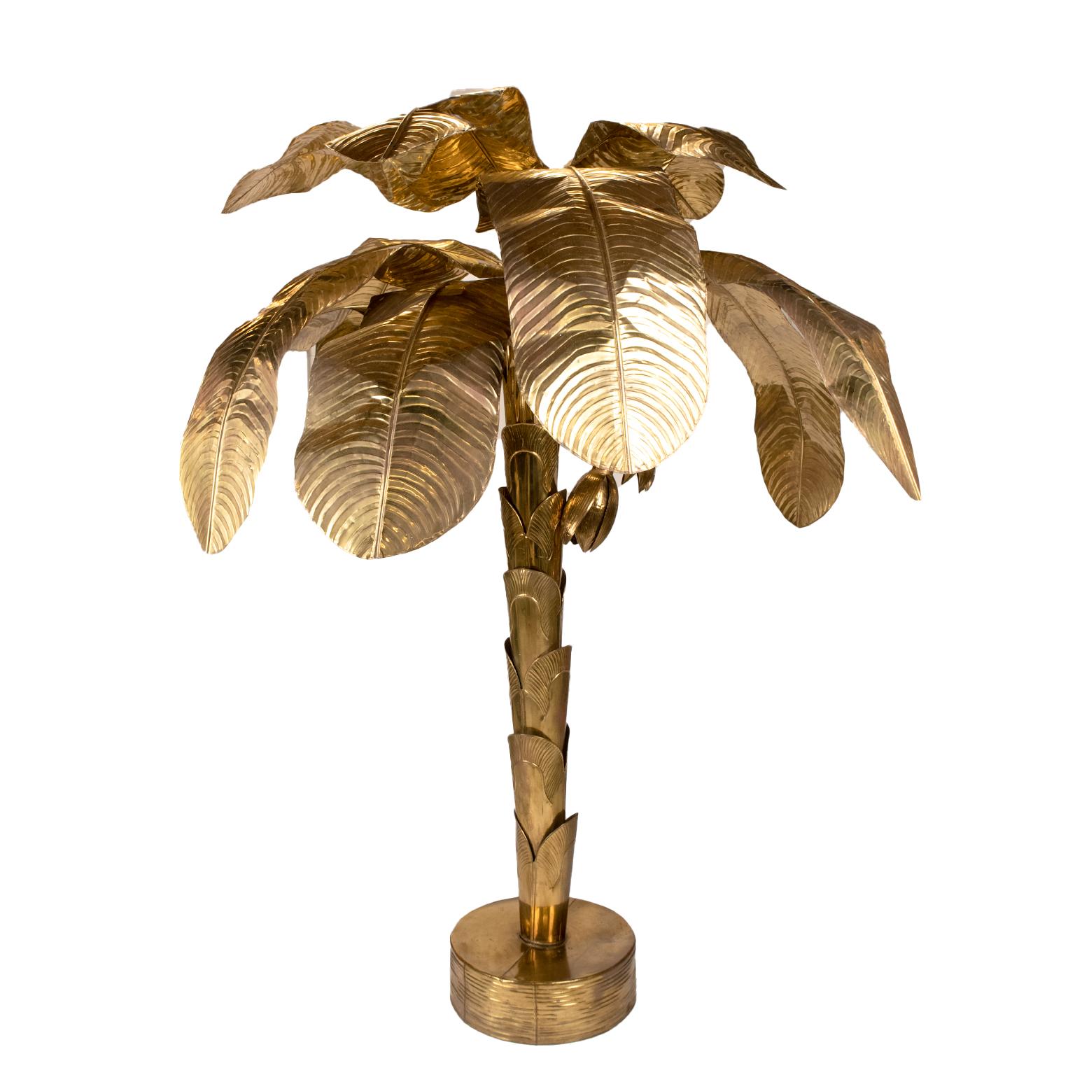 This is a stunning large aged lacquered brass palm banana tree sculpture with removable leaves surrounding a central weighted brass trunk.