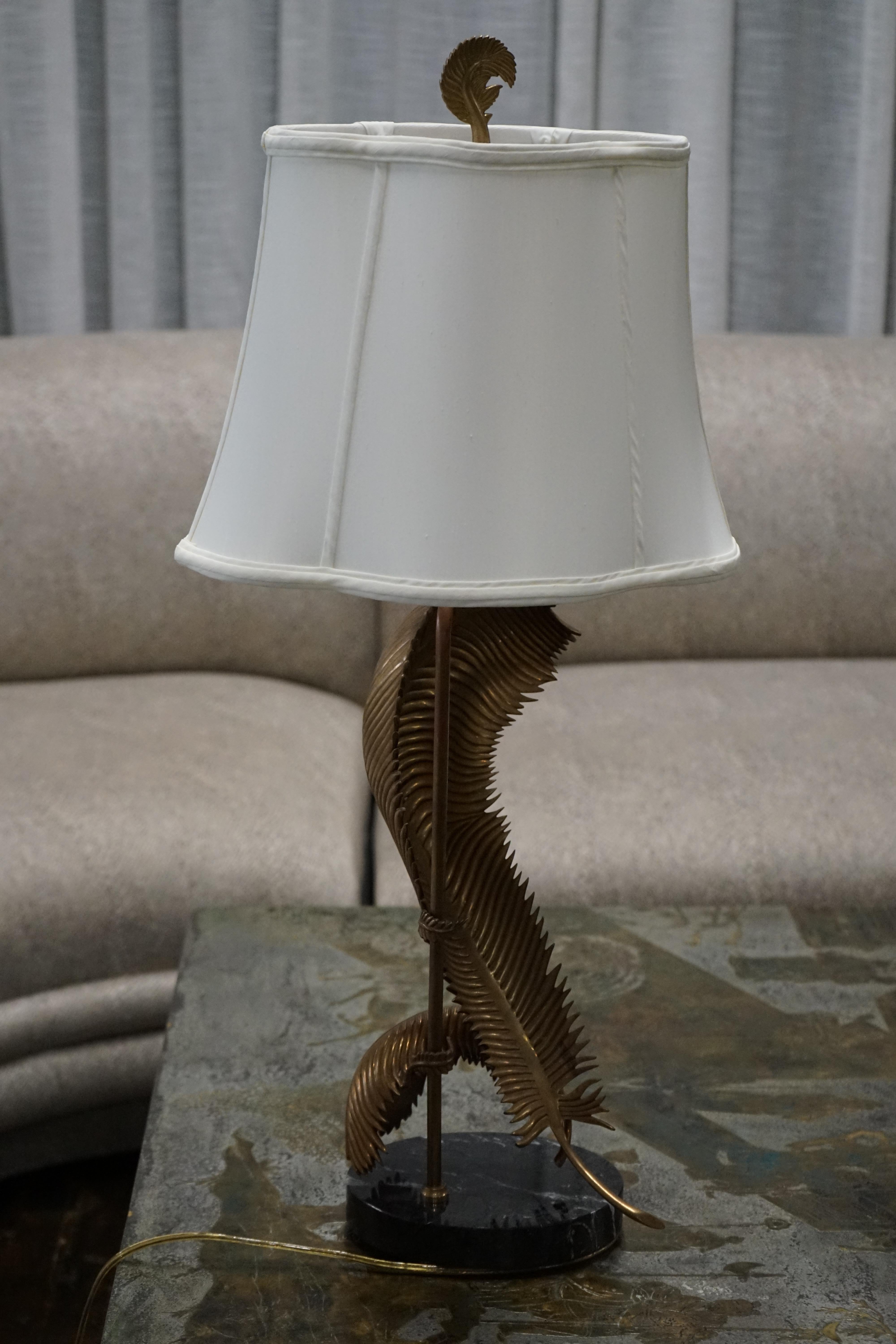 A stunning and unique table lamp by Chapman (circa 1990's).  The lamp features 2 palm fronds - in brass - that appear to be bent or swaying.  Their composition takes up much of the from of the lamp but they also very gracefully curve around the