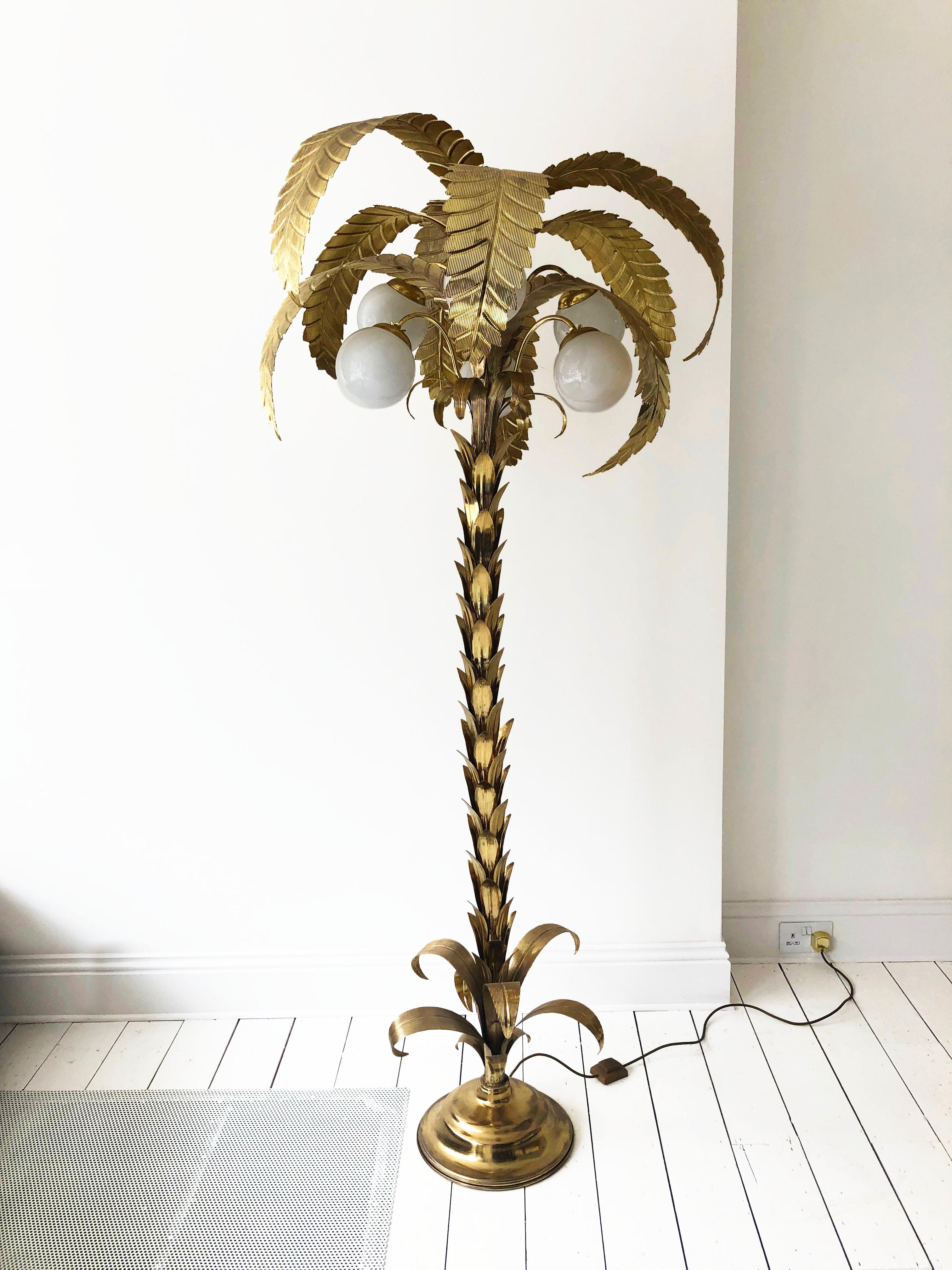 This rare 1970s brass plated palm tree floor lamp in the art deco style, reminiscent of Maison Jensen, is a truly unique and captivating piece. This tropical floor lamp exudes elegance and charm with its distinctive design and exceptional