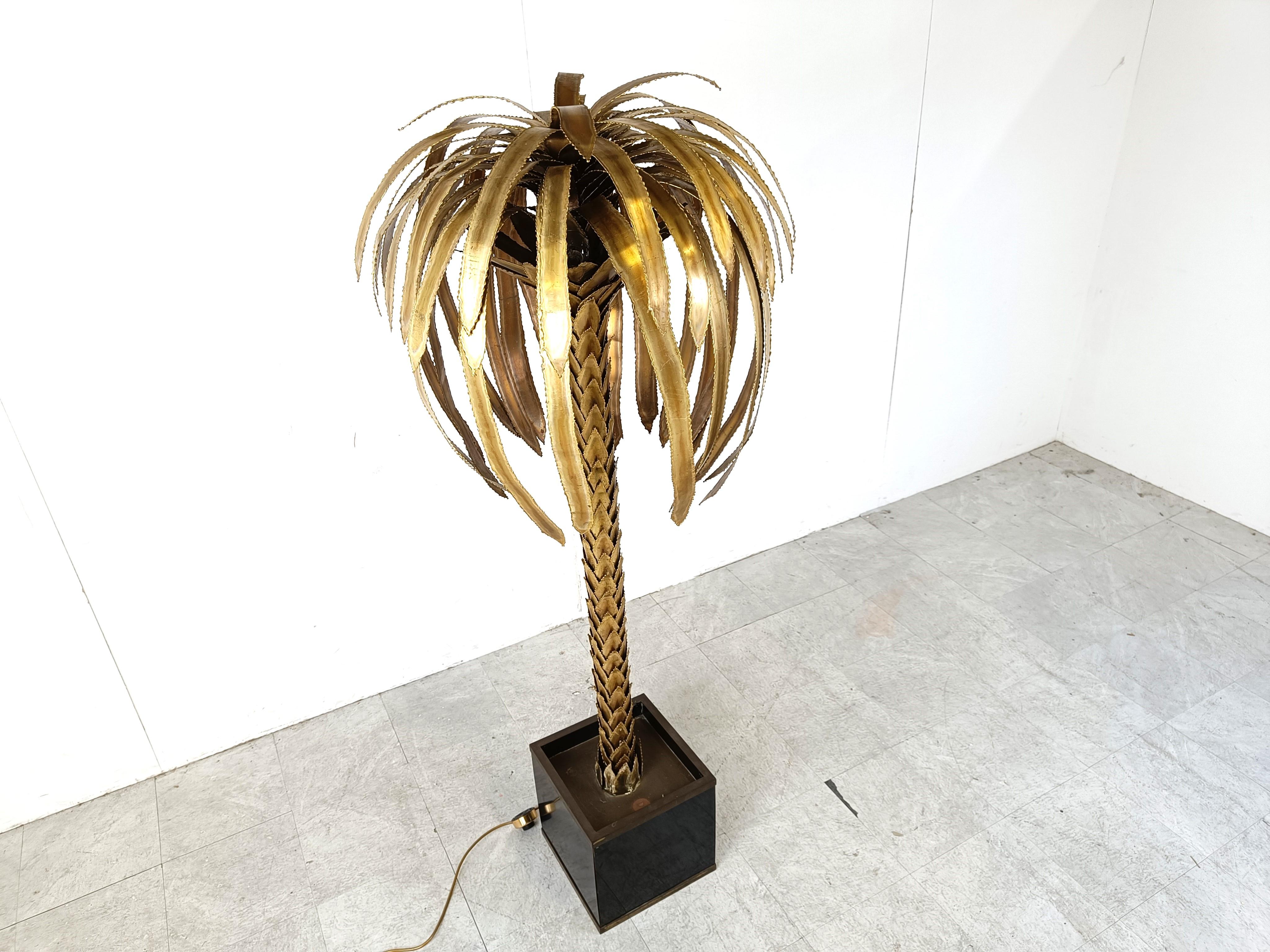 Impressive vintage torch cut brass palm tree floor lamp.

Beautifully detailed leafs and tree trunk.

The lamp emits a beautiful light.

Lacquered wooden base with brass details.

Good condition

Tested and ready to use.

1970s -