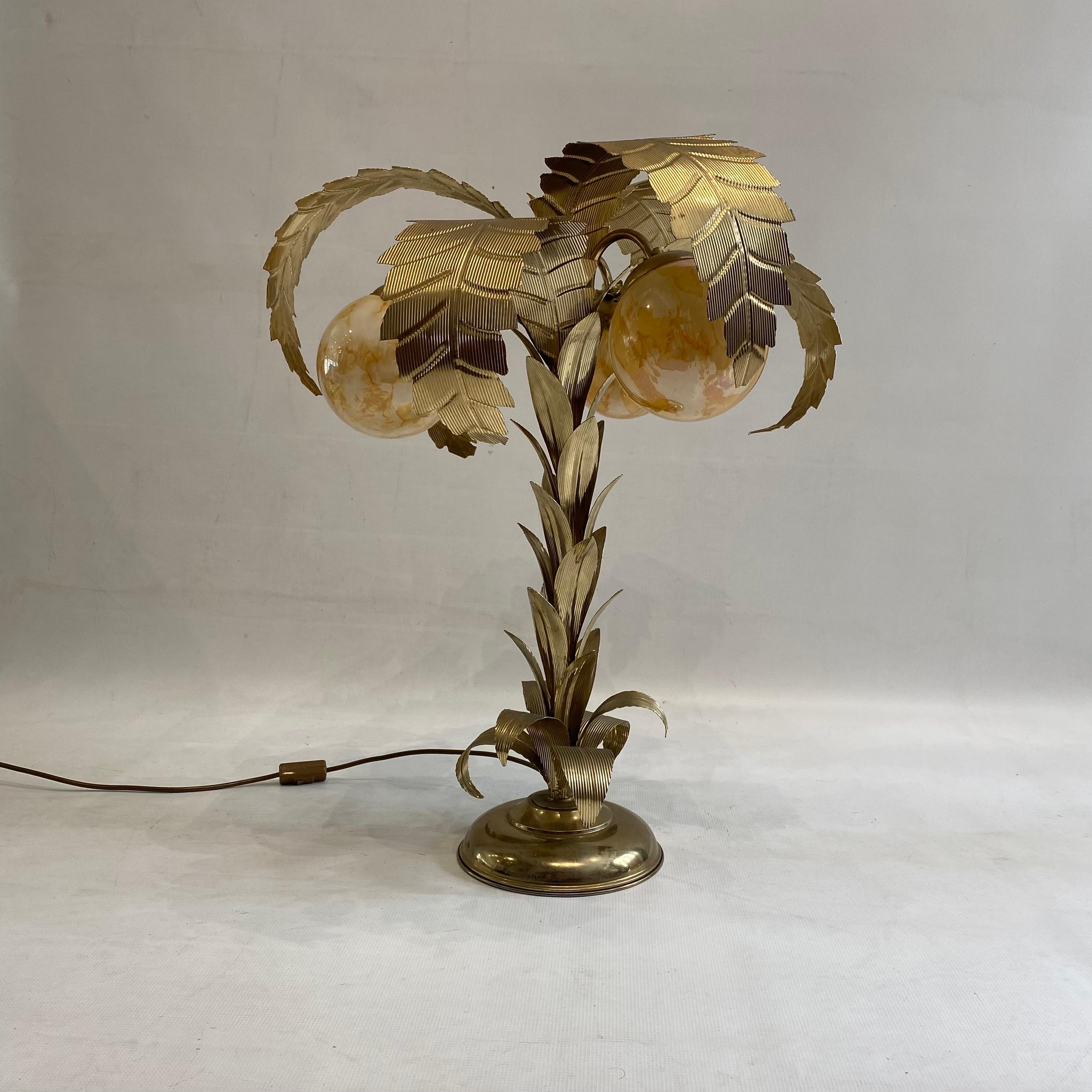 This rare 1970s brass plated palm tree table lamp in the art deco style, reminiscent of Maison Jensen, is a truly unique and captivating piece. This tropical table lamp exudes elegance and charm with its distinctive design and exceptional