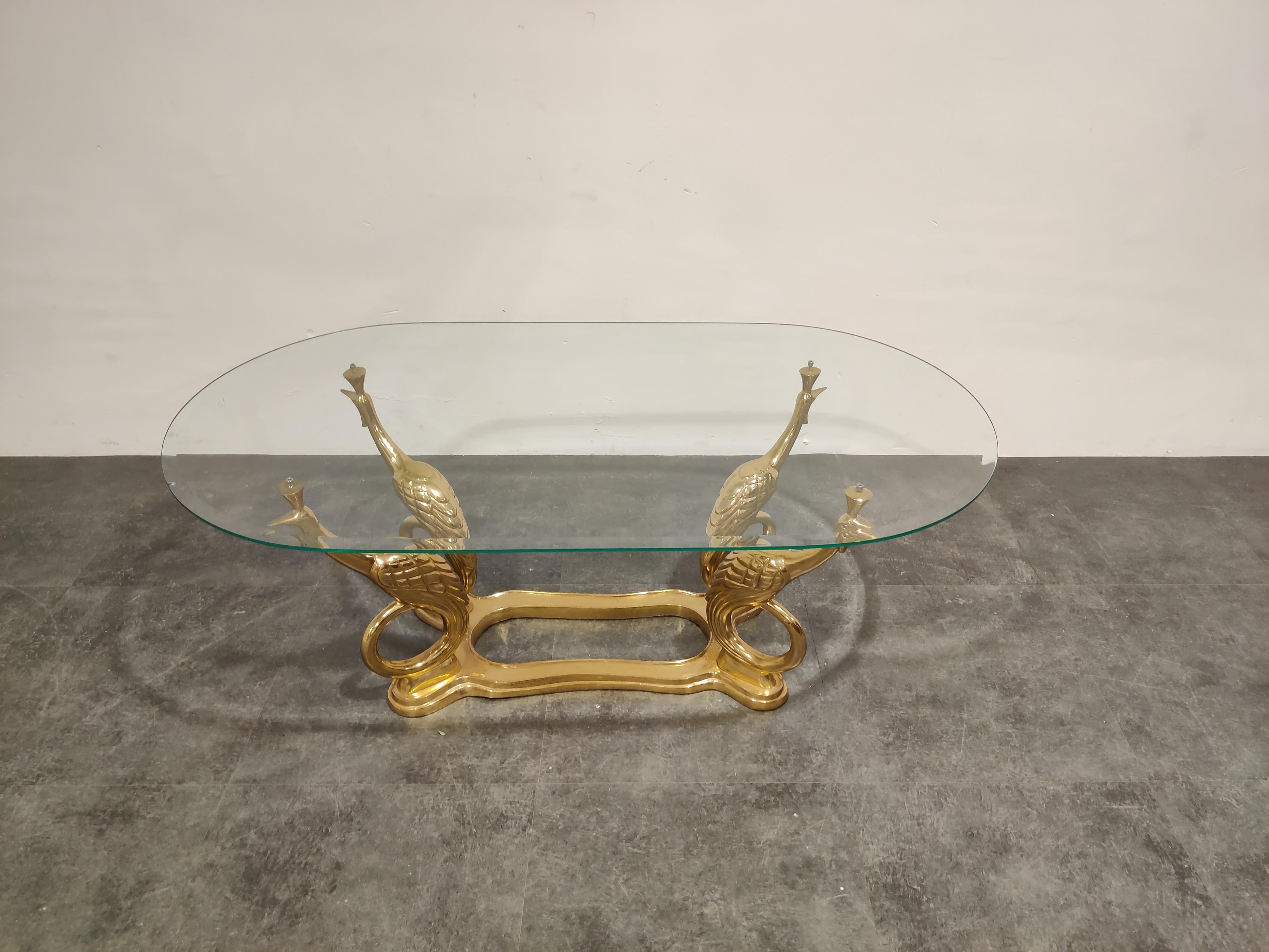 Sculptural brass peacock coffee table with a clear oval beveled glass top.

Great eye catching coffee table.

1970s - Belgium

Good overall condition with a small chip to the glass.

Dimensions:
Height 45cm/17.71