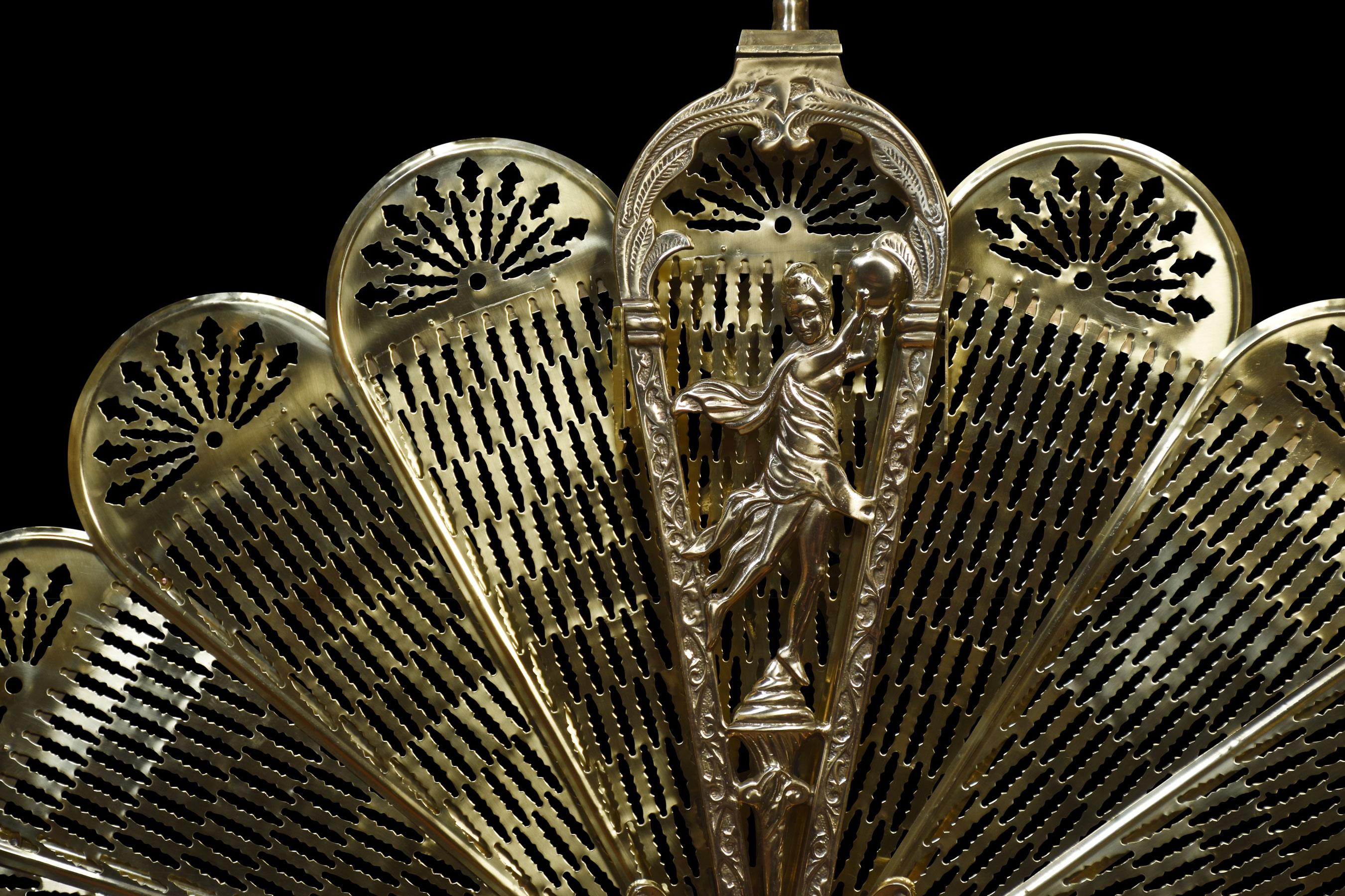 Brass peacock fire fan, of petal form frame with pierced finial holding nine conforming reticulated expanding segments, supported on scroll acanthus base.
Dimensions
Height 35 Inches
Width 47.5 Inches
Depth 8 Inches.