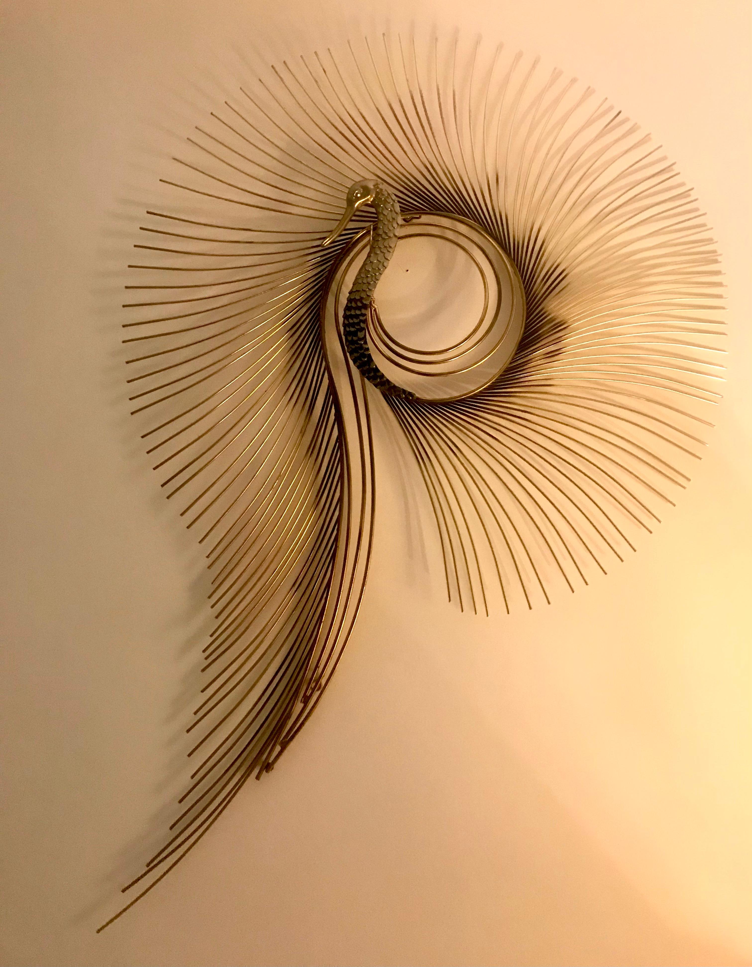 This stunning wall sculpture by Curtis Jere is very detailed. The peacock head and body are patinated cast brass and the sprays are painted gold iron. It is signed and dated: C Jere 1987 Dimensions: 39