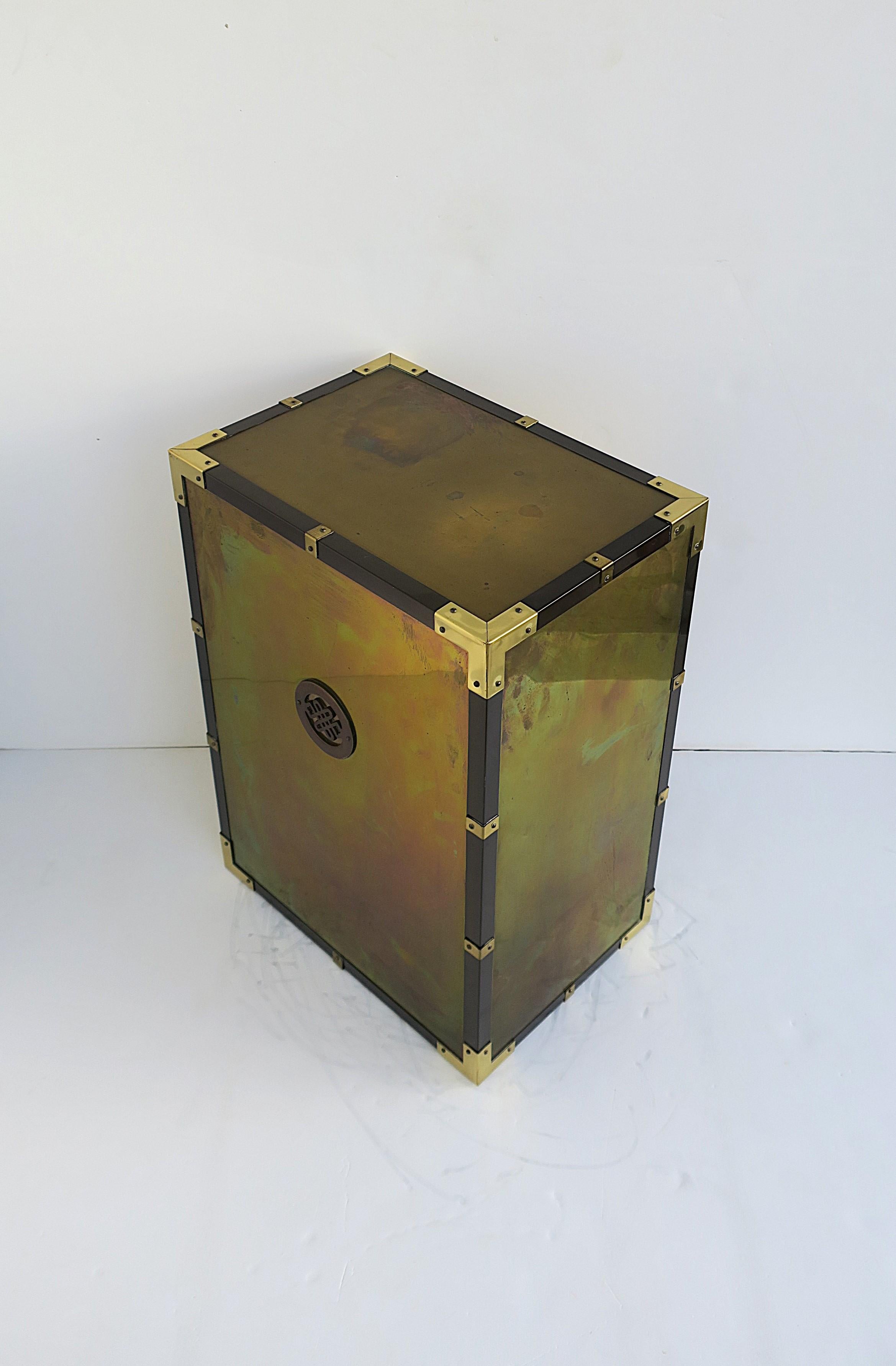 A substantial brass pedestal end/side/drinks table attributed to Mastercraft Furniture Co., circa late-20th century. This all brass able is rectangular with round medallion front (on both sides) and brass hardware along edge. A great piece to used