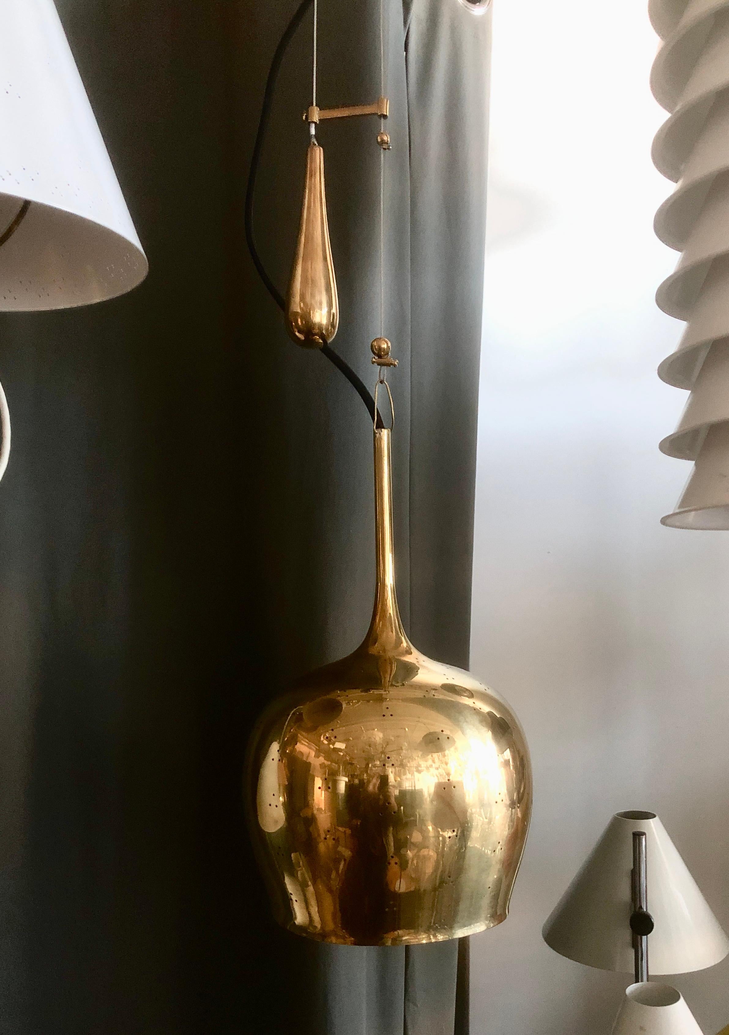A pendant designed by Paavo Tynell for Idman Oy , Model A1957, Circa 1950th. Perforated polished brass with counterweight. Newly rewired.
Total adjustable drop 62