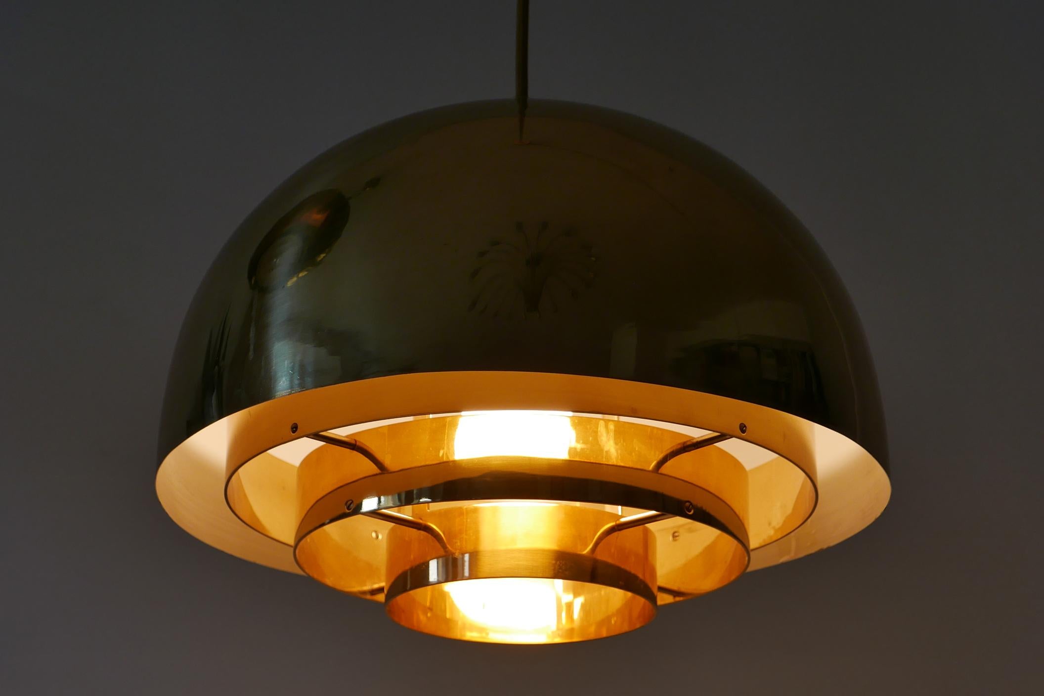 Elegante lampe suspendue ou lampe à suspension 'Dome' en laiton du milieu du siècle dernier. Fabriqué par Vereinigte Werkstätten Munich, années 1960, Allemagne.

Réalisée en tôle de laiton, elle est livrée avec un support d'ampoule à vis E27 Edison,