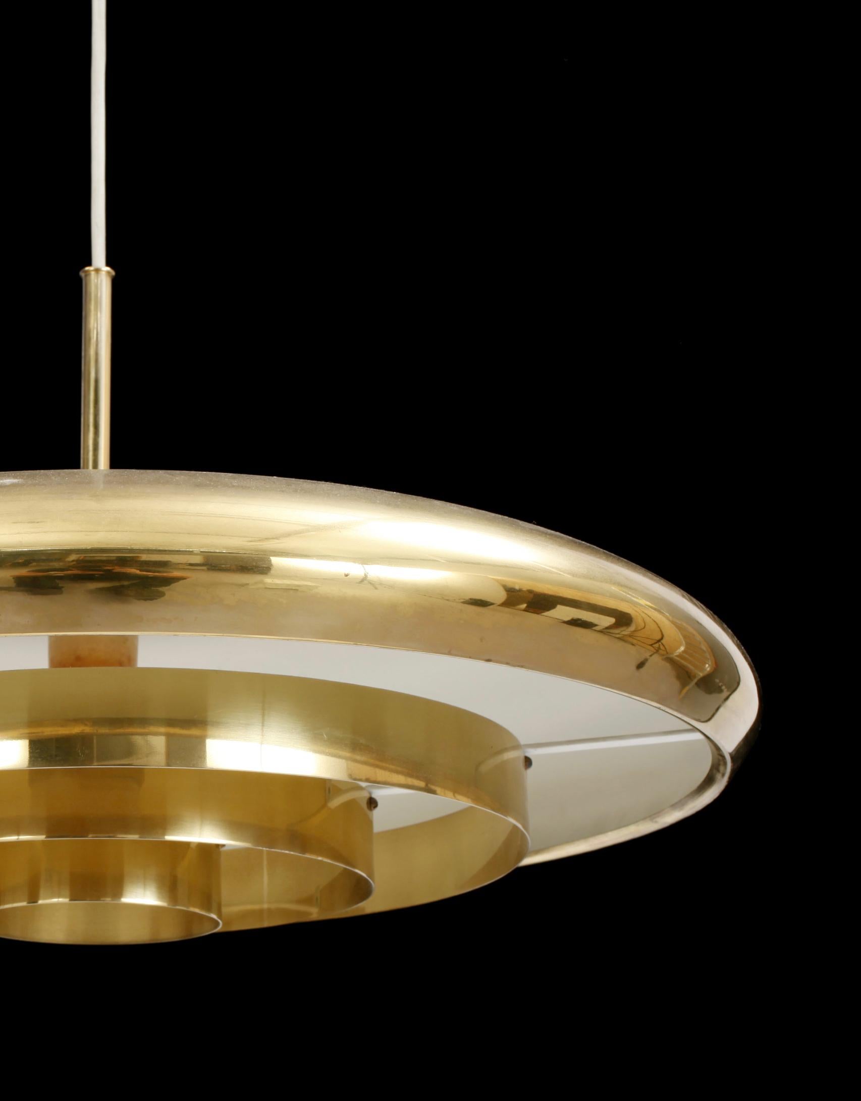 A large brass pendant light by Bergboms of Sweden, around 1960. A rare piece, well made, and a nice example of Scandinavian modern design. 
The piece is in vintage condition with some wear in line with age, mainly to the lacquer of the upper shade