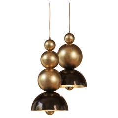 Brass pendant light with staggered twin composition
