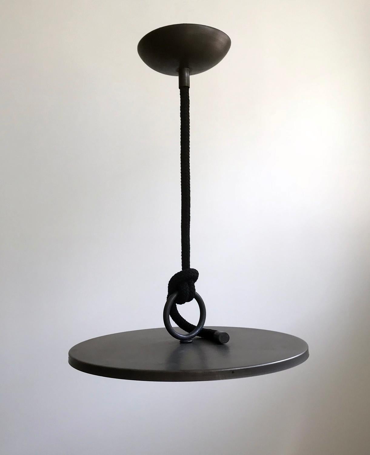 A large contemporary LED pendant light by Craig Jenkins. Hand spun brass housing and ring made in Italy.
Less than an inch at the outer edge and 23 inches in diameter. 7 inches in total height.
Suspended from a large ceiling canopy by a thick,