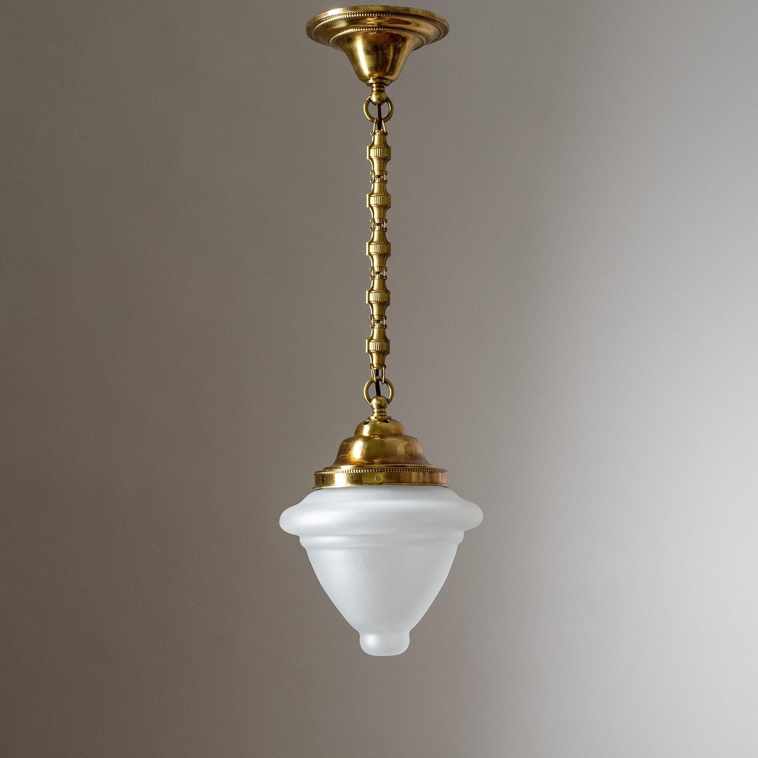 Fine Austrian brass pendant from the 1920s. Clear glass diffuser with a satin finish on the outside. One original brass and ceramic E27 socket with new wiring. Height without chain is approximately 13inches/34cm.