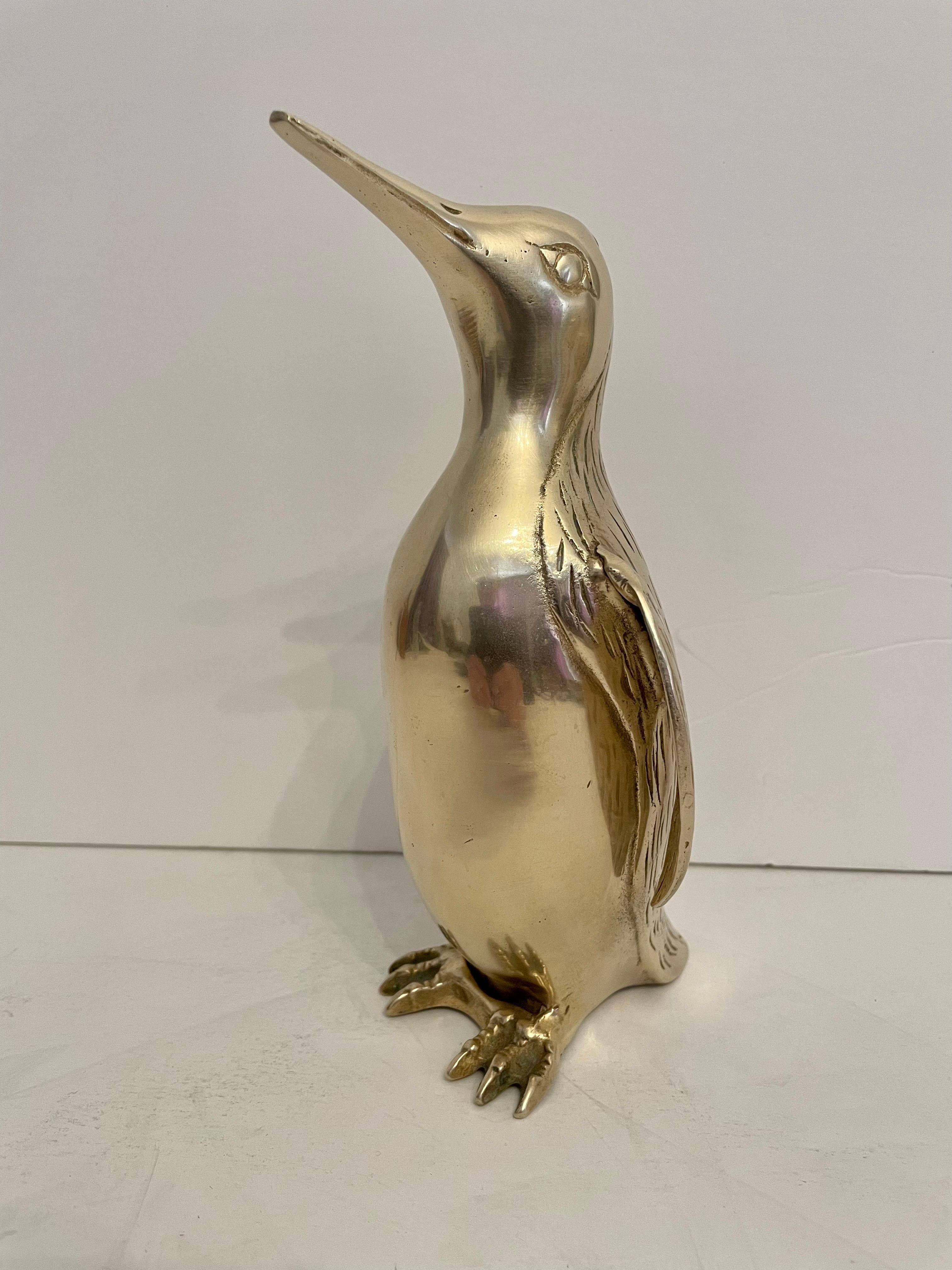 Vintage Hollywood Regency brass Penguin sculpture. Nicely detailed. Hand polished. Good overall condition. Dark and light spots are reflection of light in photos. Measures 8” tall x 4.25” wide x 4.25” deep. Remnant of Korea stick on underside. QUICK