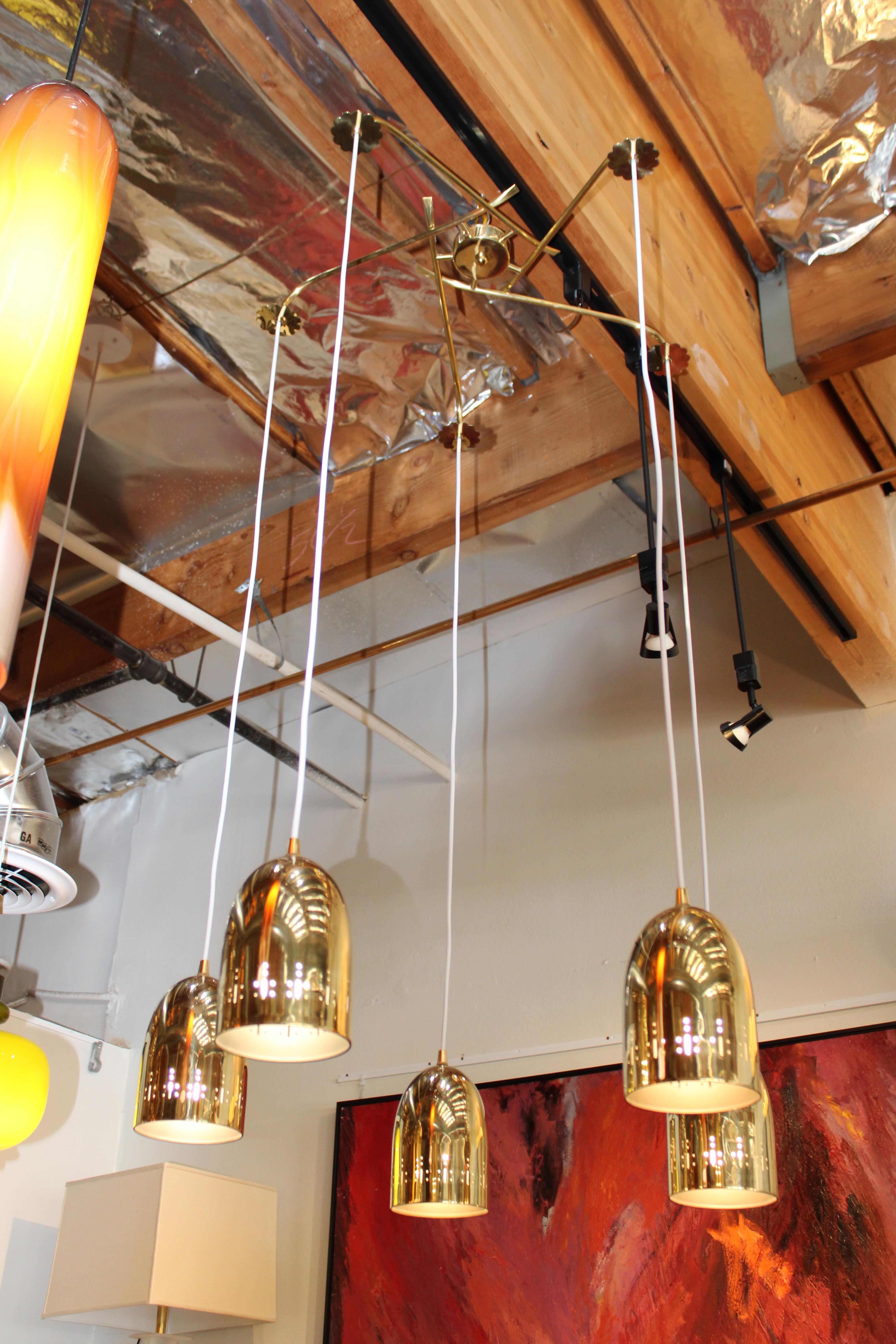Brass midcentury chandelier with 5 perforated canisters.  Total height from top of cap to the bottom of brass fixtures is about 51