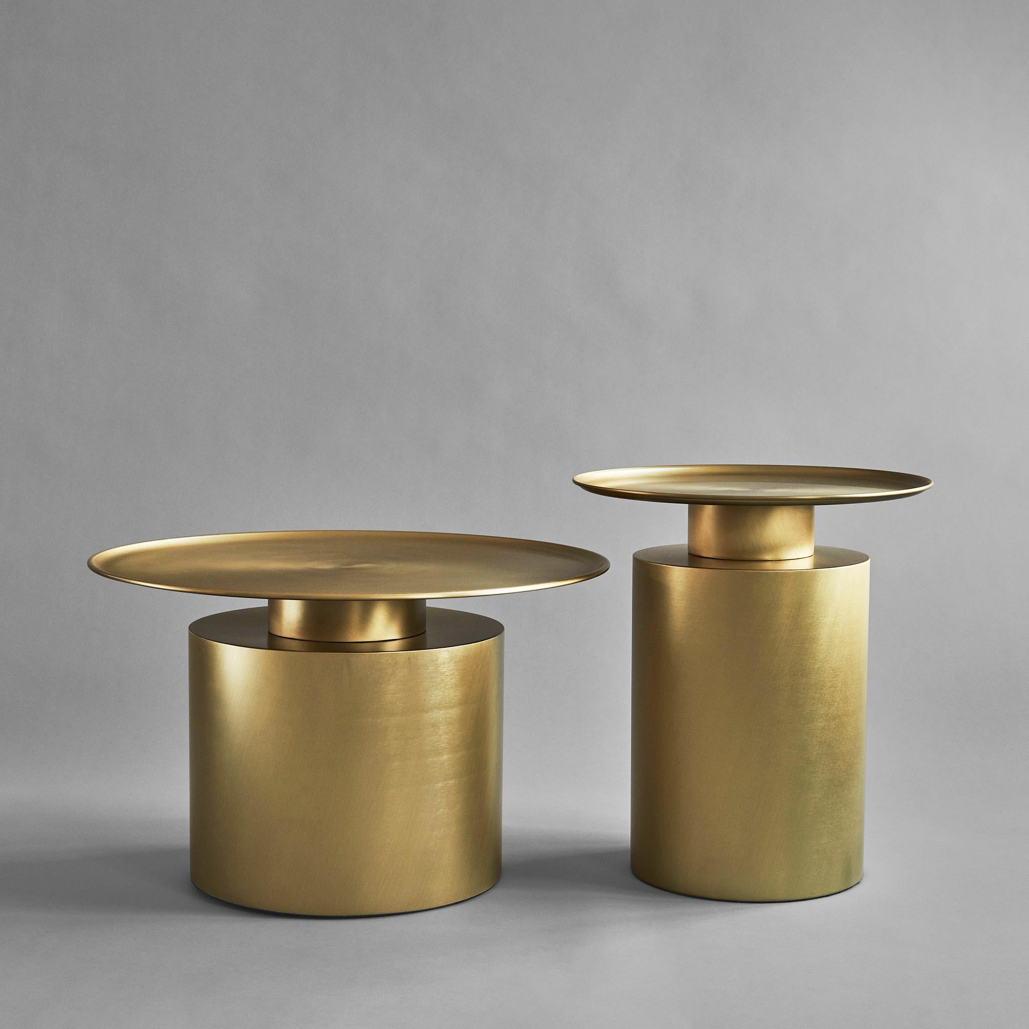 Brass pillar table low by 101 Copenhagen
Designed by Kristian Sofus Hansen & Tommy Hyldahl
Dimensions: L41 / W65 /H65 CM
Materials: plated metal

Pillar is inspired by the rich lustrous use of material in the 1930´s Art Deco movement. The