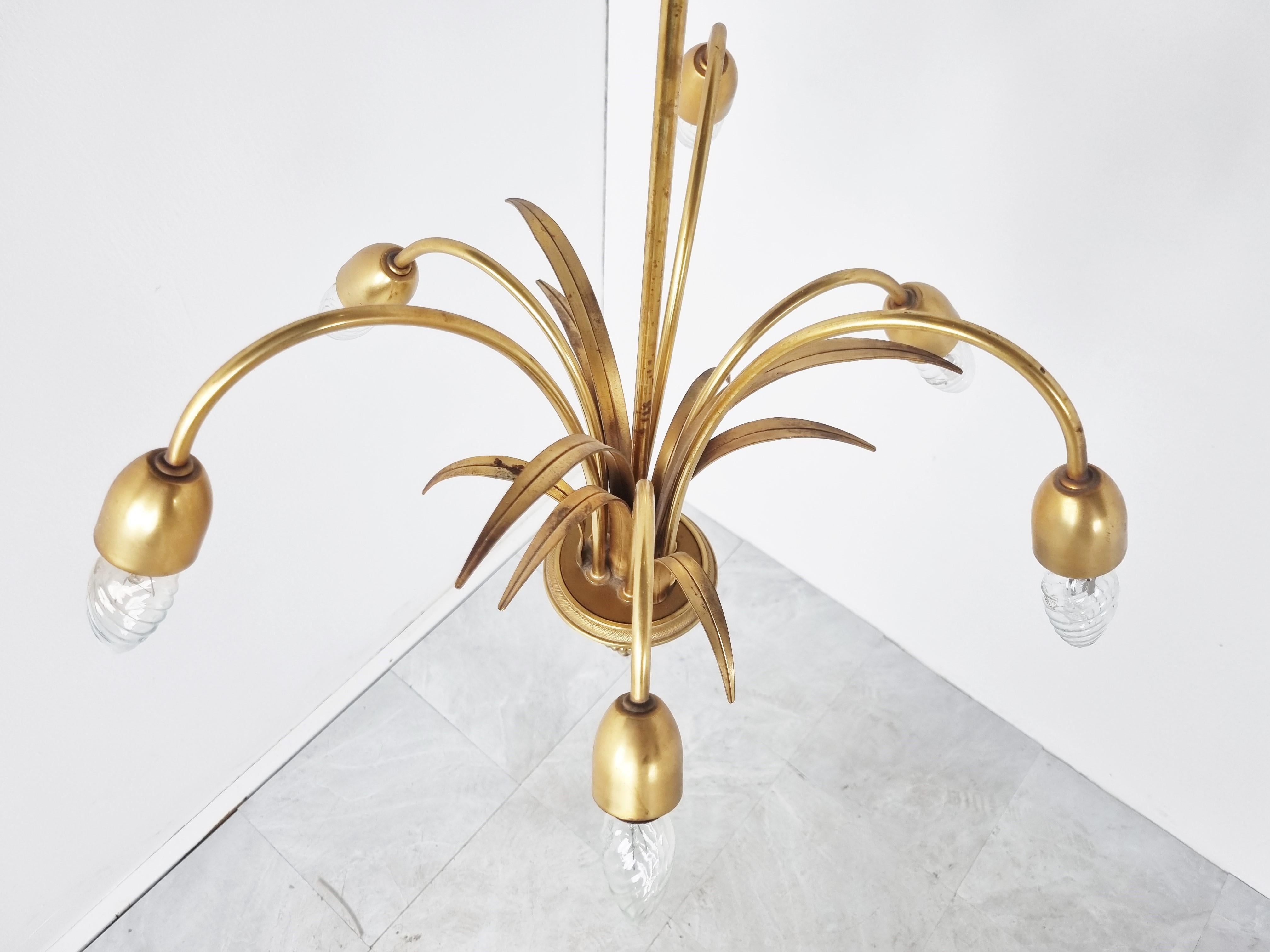 Elegant brass pineapple leaf chandelier by Boulanger, a Belgian lighting company.

Hollywood regency style

Good vintage condition with patina on the brass. Tested and ready for use with regular candelabra E14 light bulb sockets.

1970s,