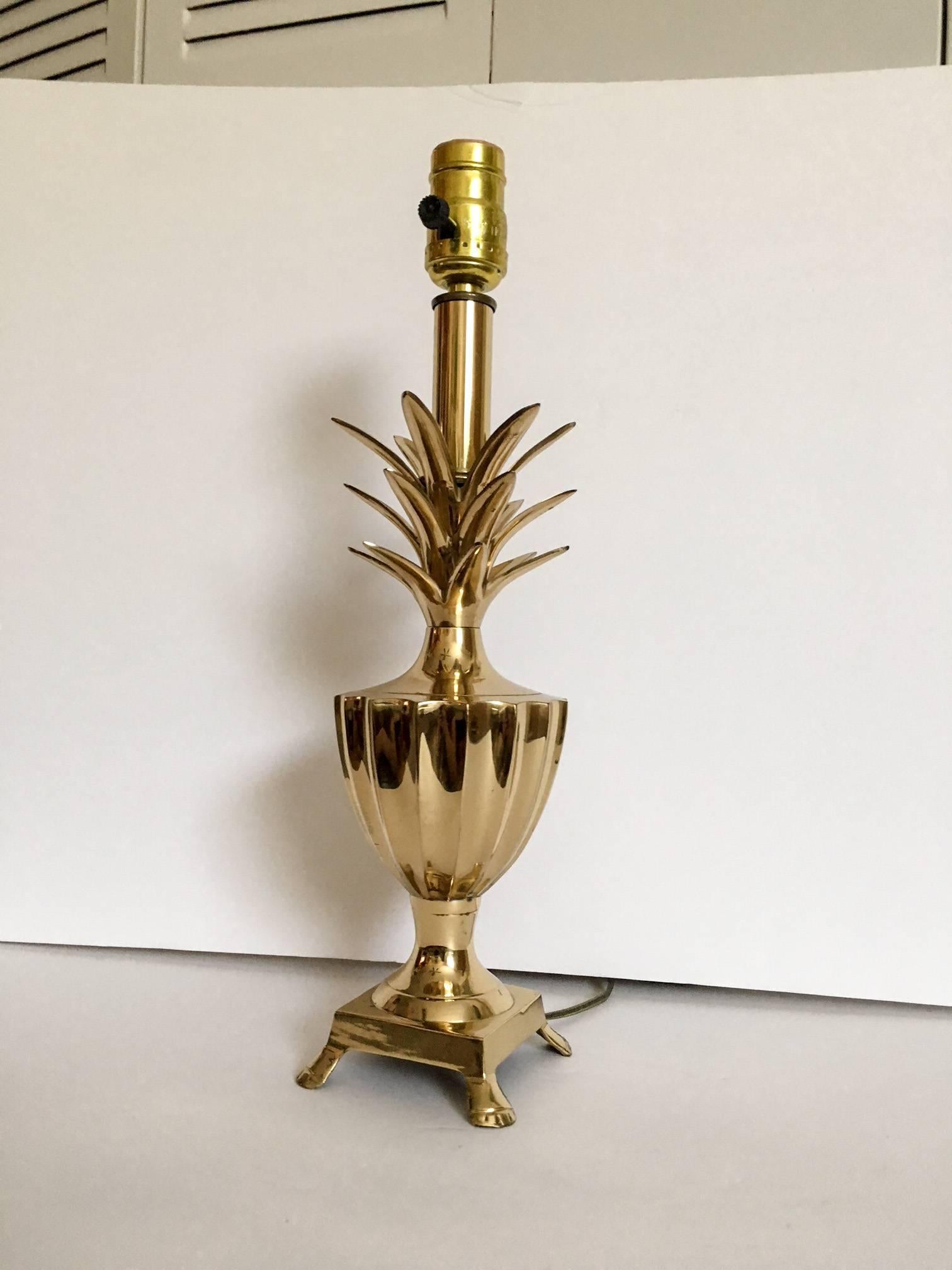Solid lacquered brass pineapple shaped accent lamp on a footed base. Lamp uses a standard light bulb; 60W candle tip bulb recommended. A clip on shade will be needed for this piece. Original wiring in working condition.