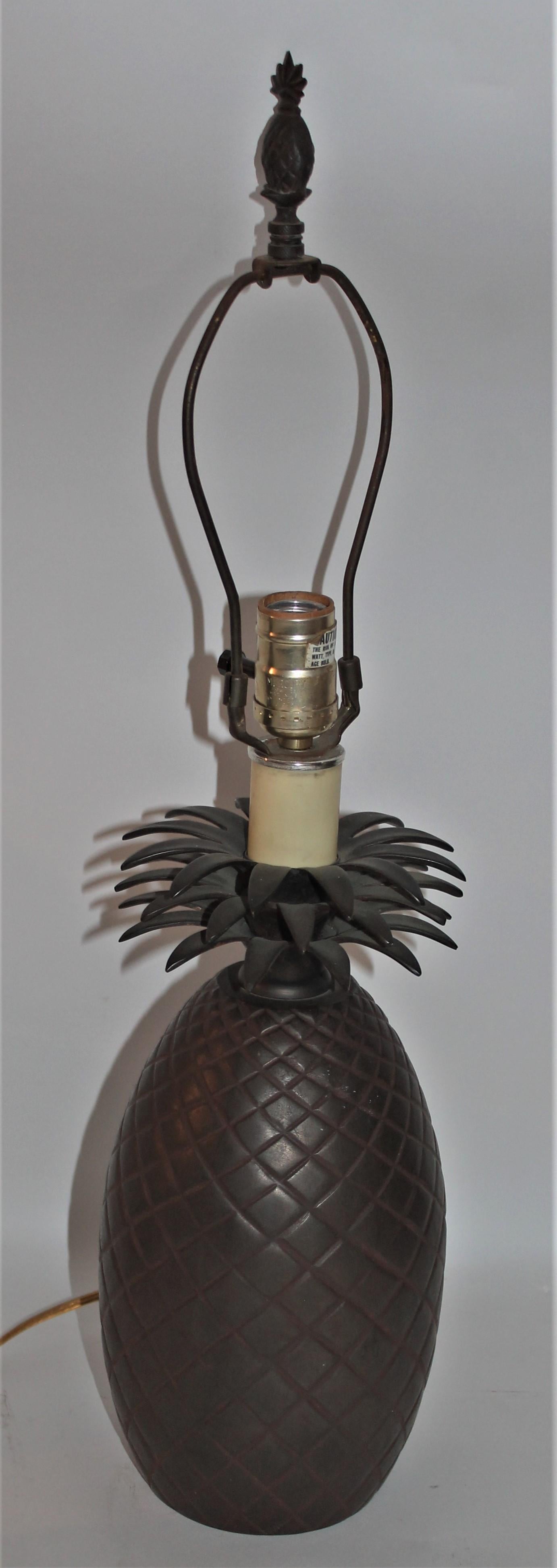 This vintage solid brass pineapple table lamp is in Fine as found condition. It is newly wired and has a brass finial that is a pineapple shape as well. The lamp is in working order. The lamp has a great patina.