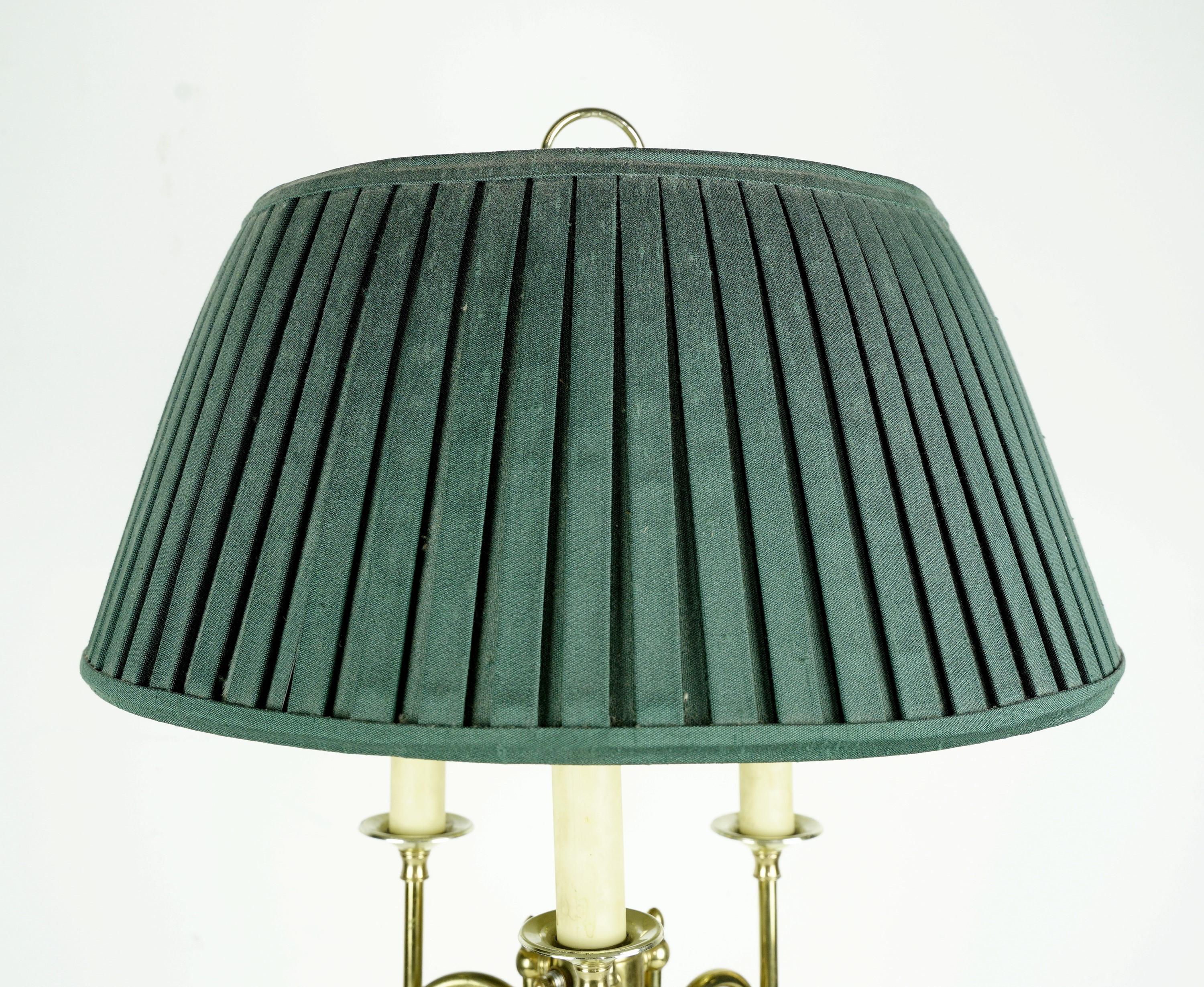 Colonial style table lamp with a polished brass finish and the original pleated green shade. Takes three standard candelabra light bulbs. Cleaned and restored. Small quantity available at time of posting. Please inquire. Priced each. Please note,