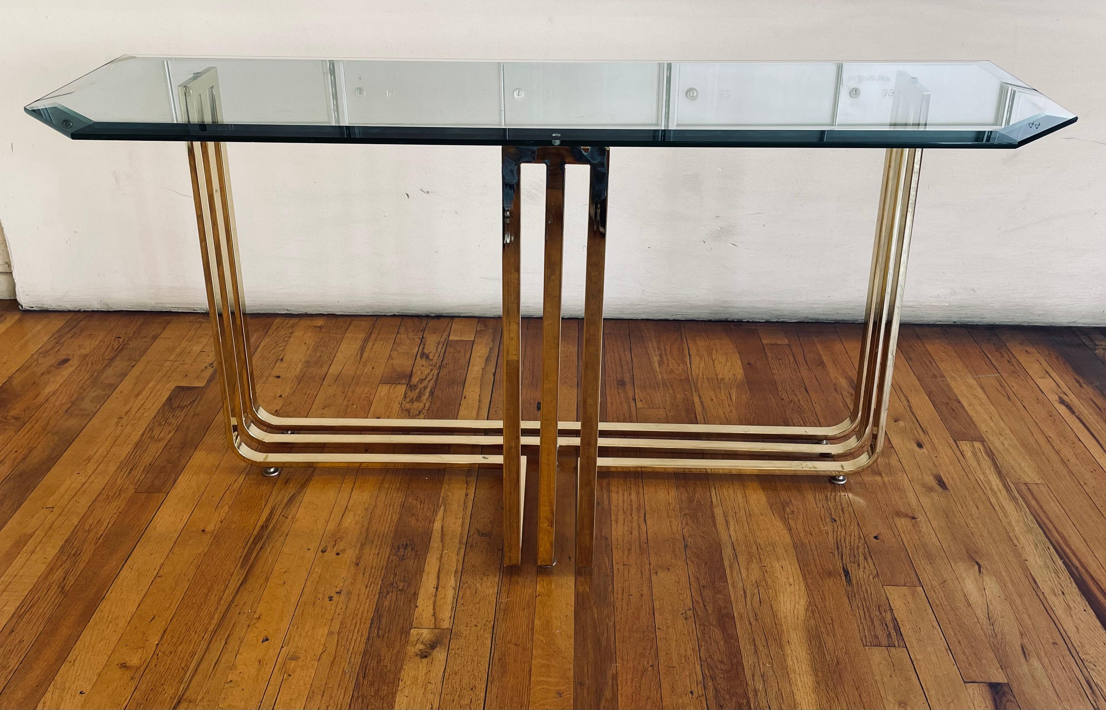 Beautiful brass polished flat metal and beveled glass top console table, beautiful simple elegant, circa 1980's.Post-modern design.