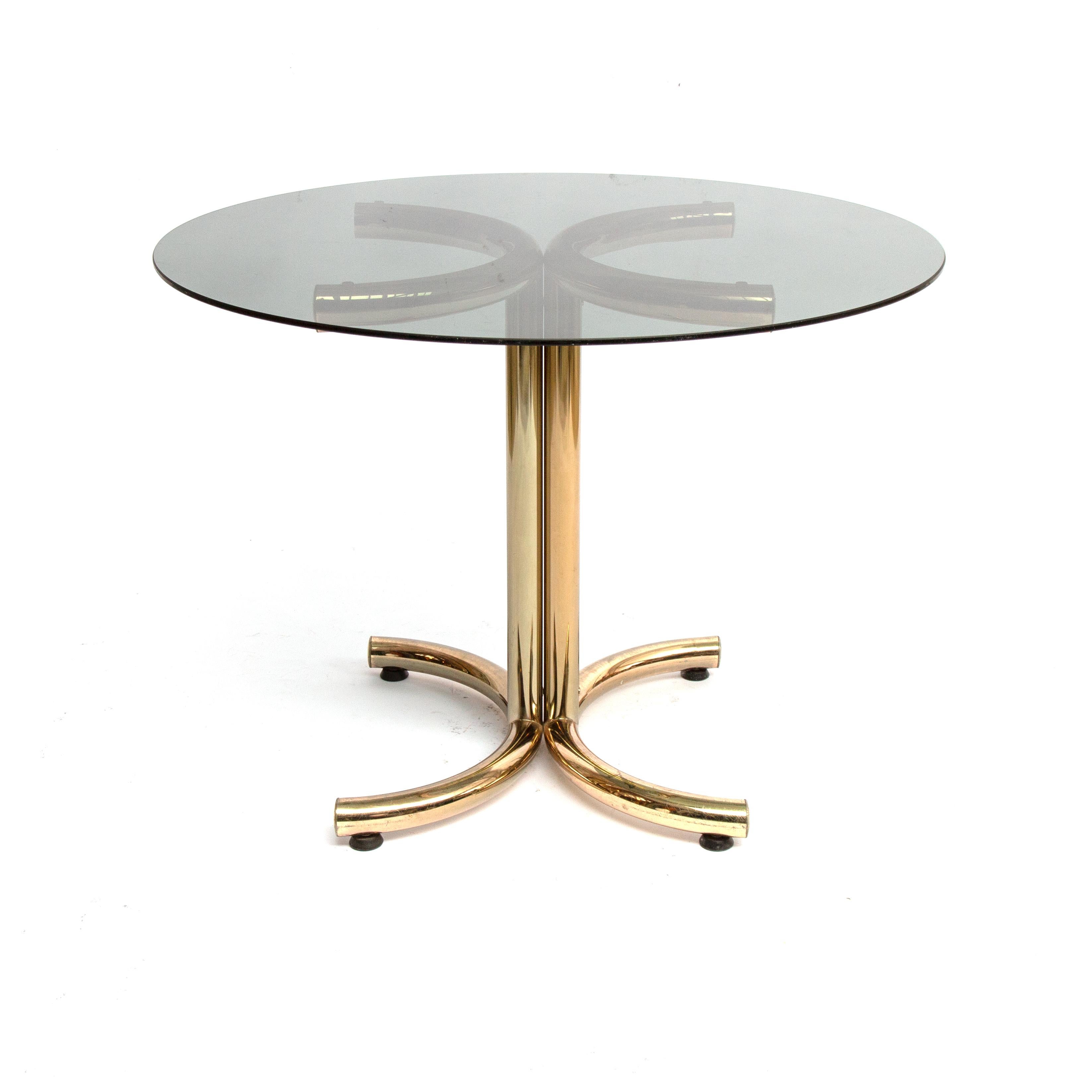 1970s brass plated chrome base and smoked glass round dining table by Giotto Stoppino. Midcentury brass and smoked glass round table 120cm diameter by Giotto Stoppino 1970s. In good used vintage condition. On one end of the frame a rod end misses.