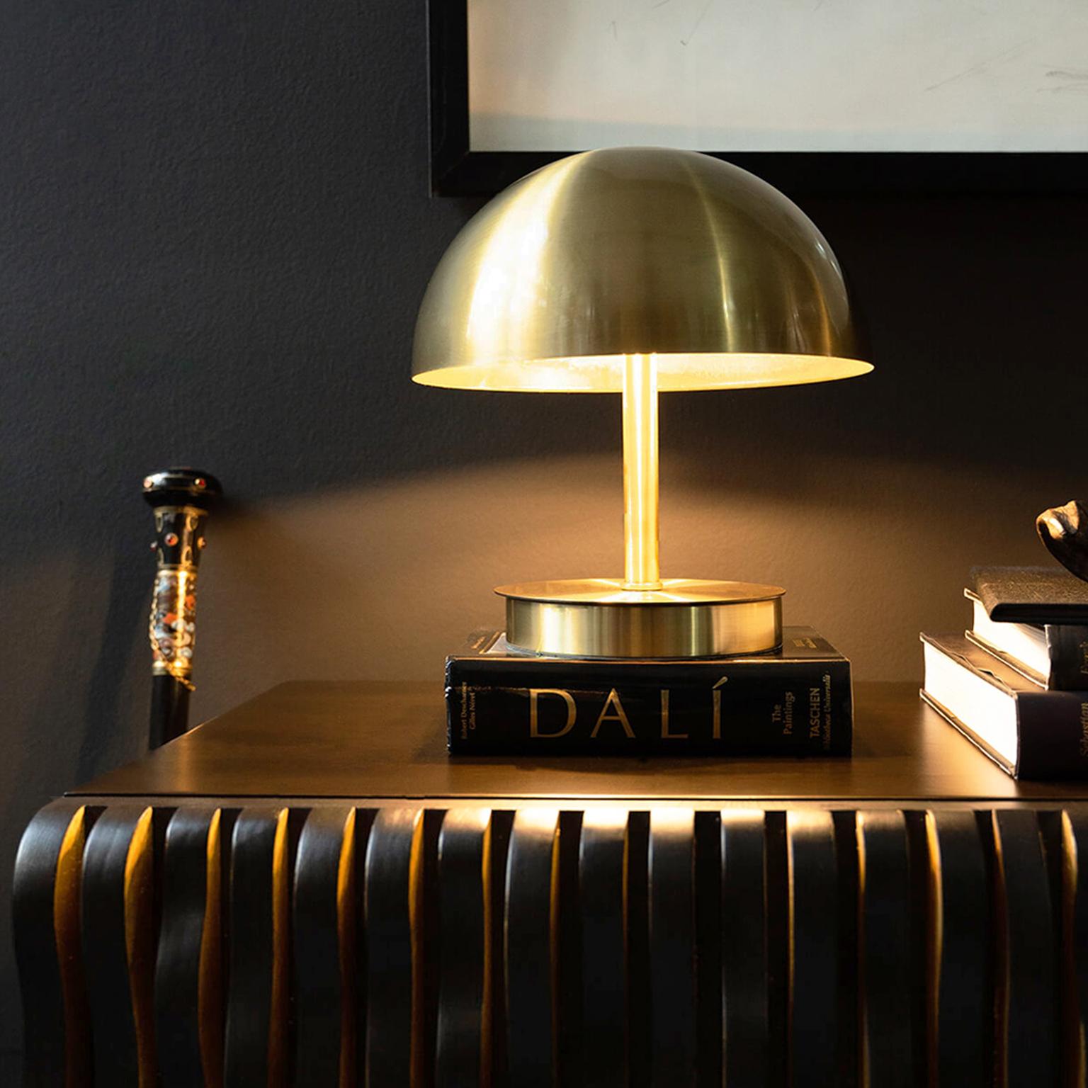 The ORB table lamp offers a flawless form in brass plated metal to illuminate your space with quality and elegance...

The Orb Table Lamp, which is in the shape of a hemisphere, stands out not only as a functional lighting but also for its simple