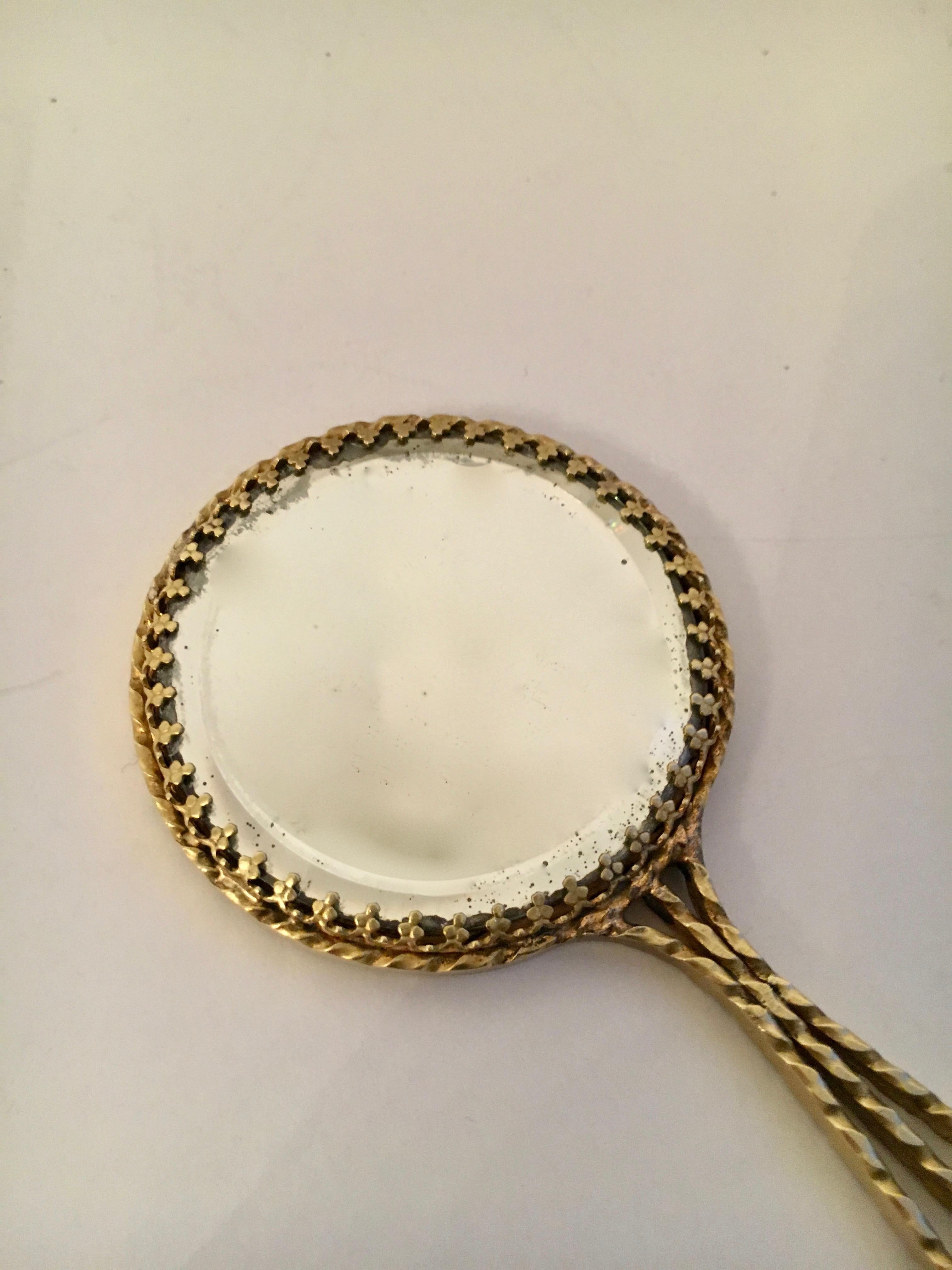 Brass pocket mirror - the small mirror is great for the pocket, bag, back pack or desk. Double sided with mirror on both sides the same, no magnification. Some hazing on the mirror, but we believe it adds to the elegance and, in no way, detracts