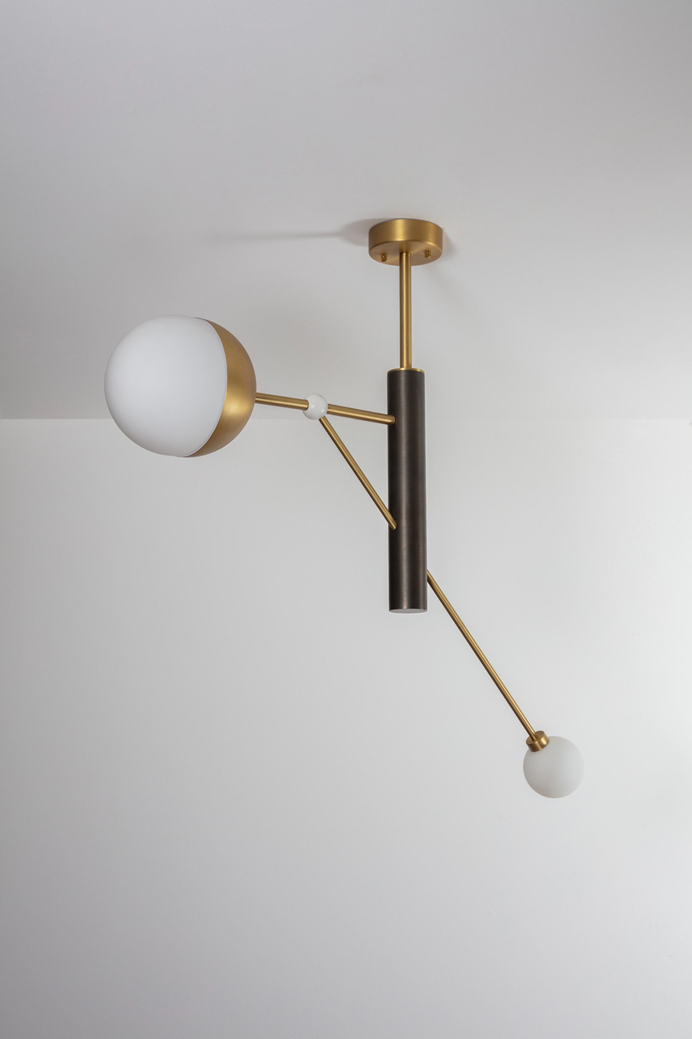 Brass Pole Dance Pendant Light by Square in Circle
Dimensions: W 87.7 x H 82 x D 20 cm.
Materials: brushed brass finish, brushed dark grey metal, white frosted glass globe.

This pendant light is inspired by Oskar Schlemmer's 1928 Pole Dance, in