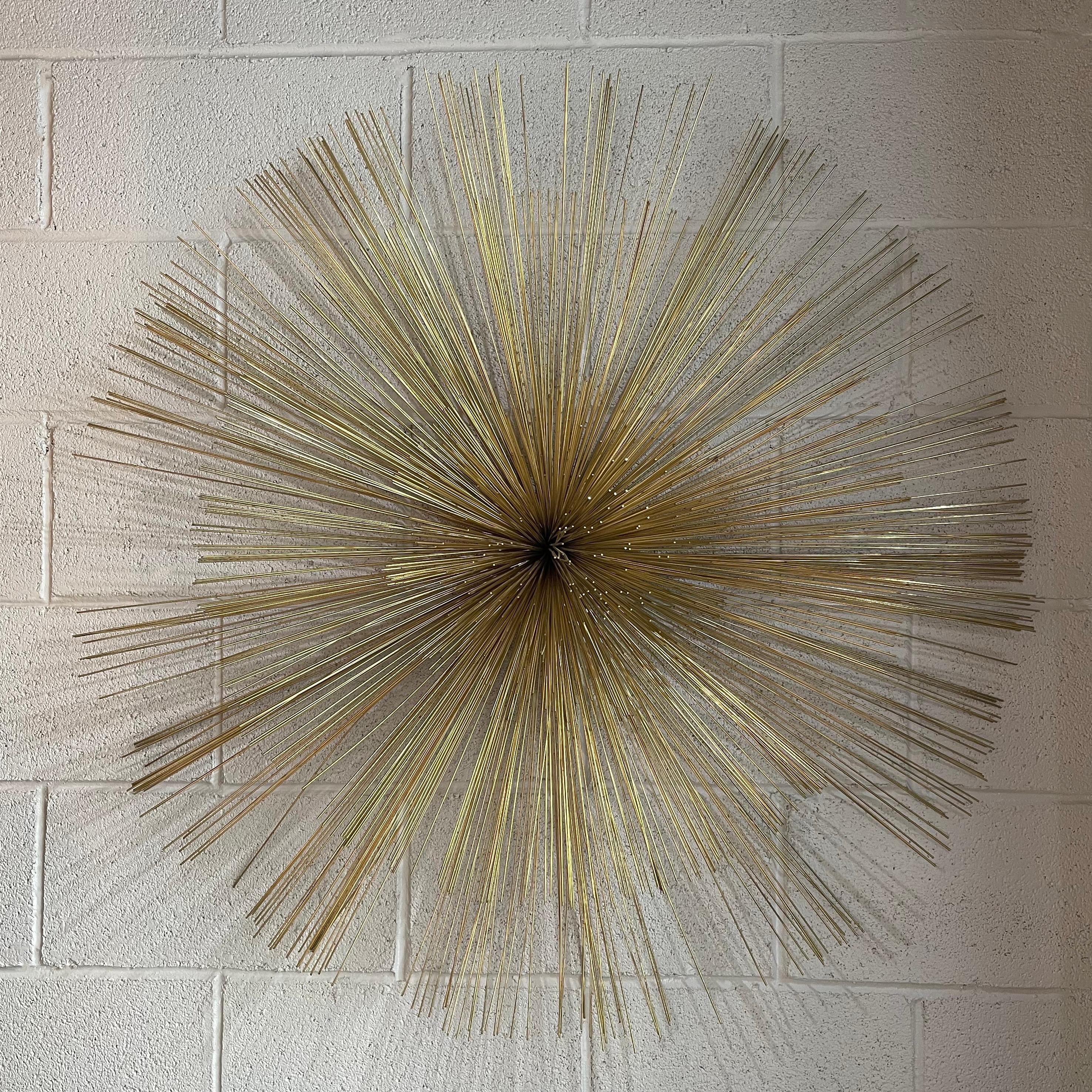 Large, impressive, pom pom wall sculpture by Curtis Jere consists of fine, brass rods eminating from a center plate signed and dated 1989.