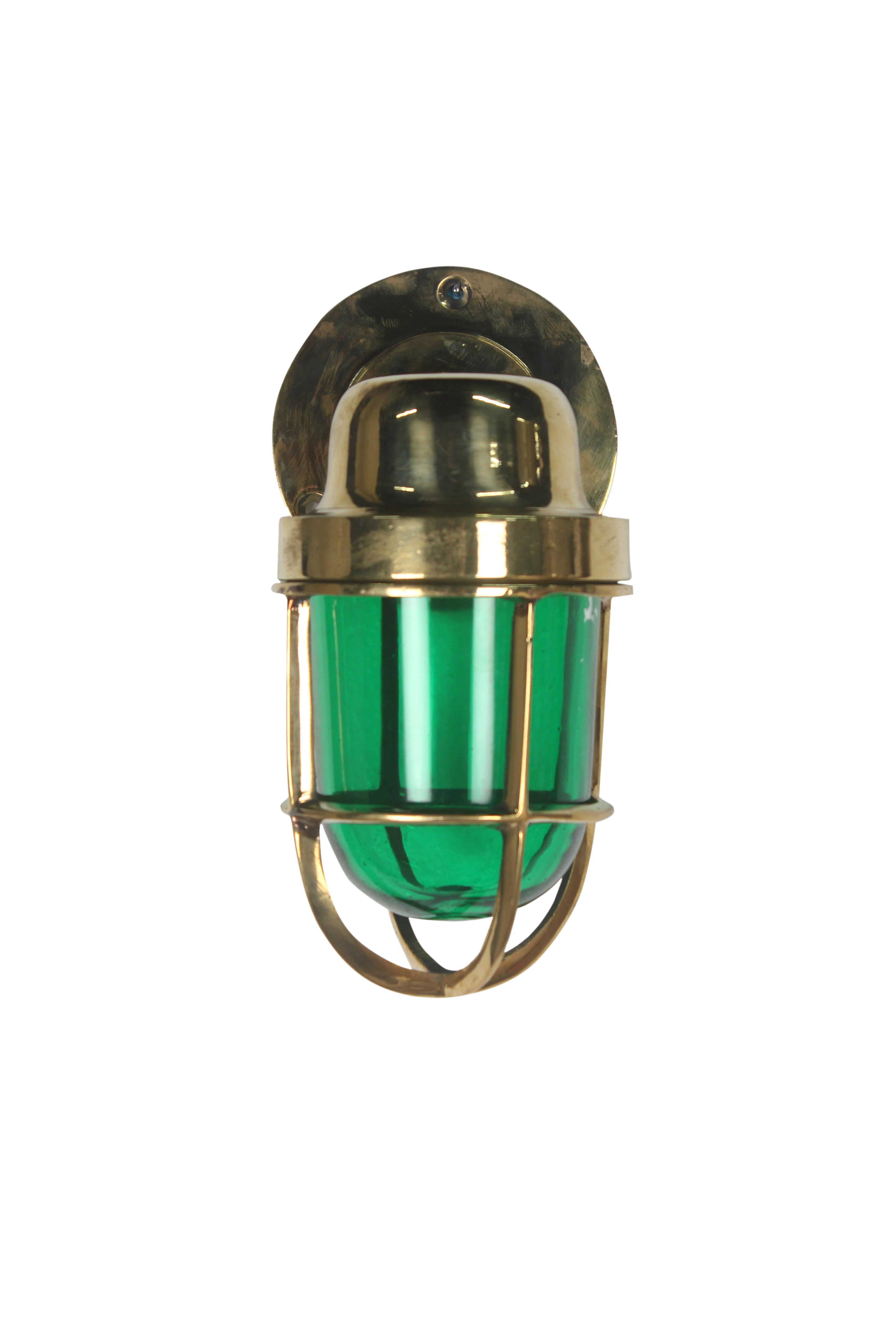 A pair of port and starboard brass cage lights from a decommissioned ship. Brass cage unscrews from the holder above as does the red or green glass shade. Rewired for American use, 1970s. Use inside or out.