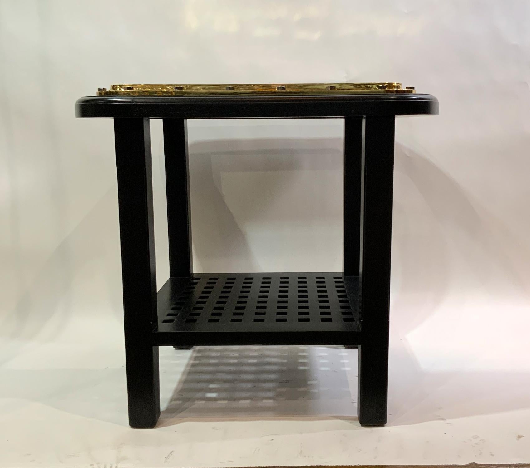 Solid brass ships porthole table. Meticulously polished and lacquered authentic ships porthole that has been fitted to a custom-built bistro table with a ships grating and four tapered legs.

Weight: 93 LBS
Overall Dimensions: 31” H x 35