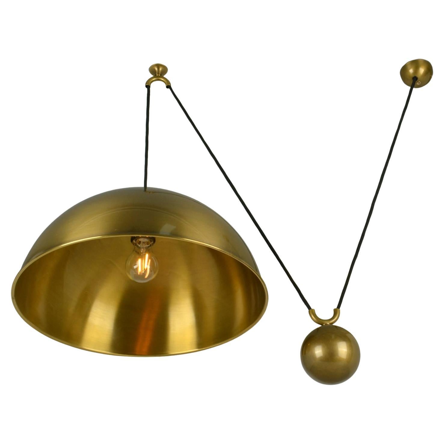 Original Counterbalance pendant 'Posa' by Florian Schulz with side weight. Strong and minimal pendant in a high quality spun and brushed brass moves smoothly up and down due to the solid brass counterweight. The brass is coated to protect from