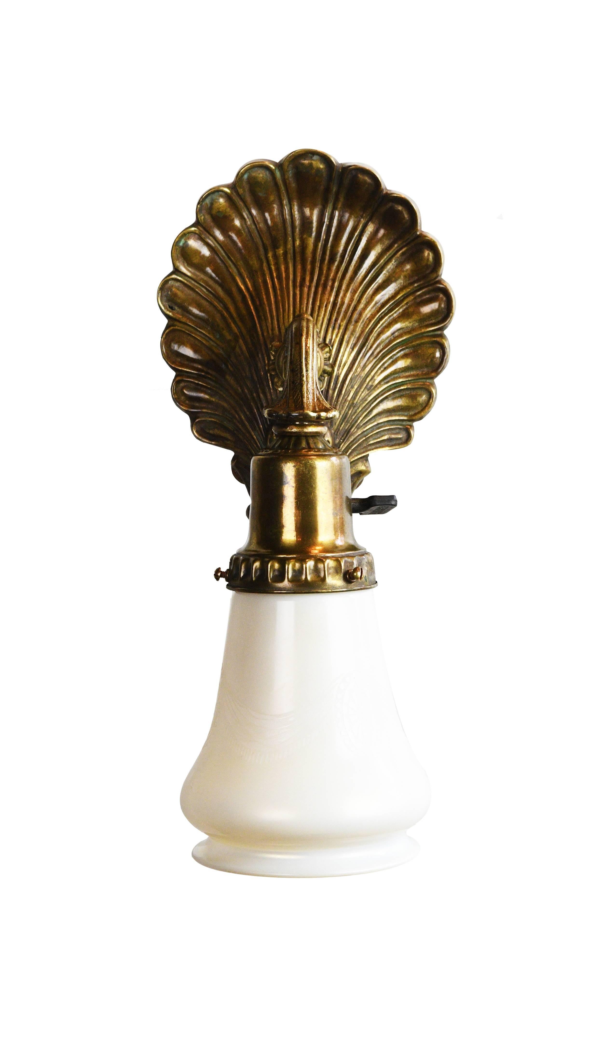 This beautiful brass Pullman train sconce has patterns consisting of organic shapes and curving lines. The design is sophisticated while remaining its simplicity. The Steuben shade is etched with subtle patterns,

circa 1925
Condition: