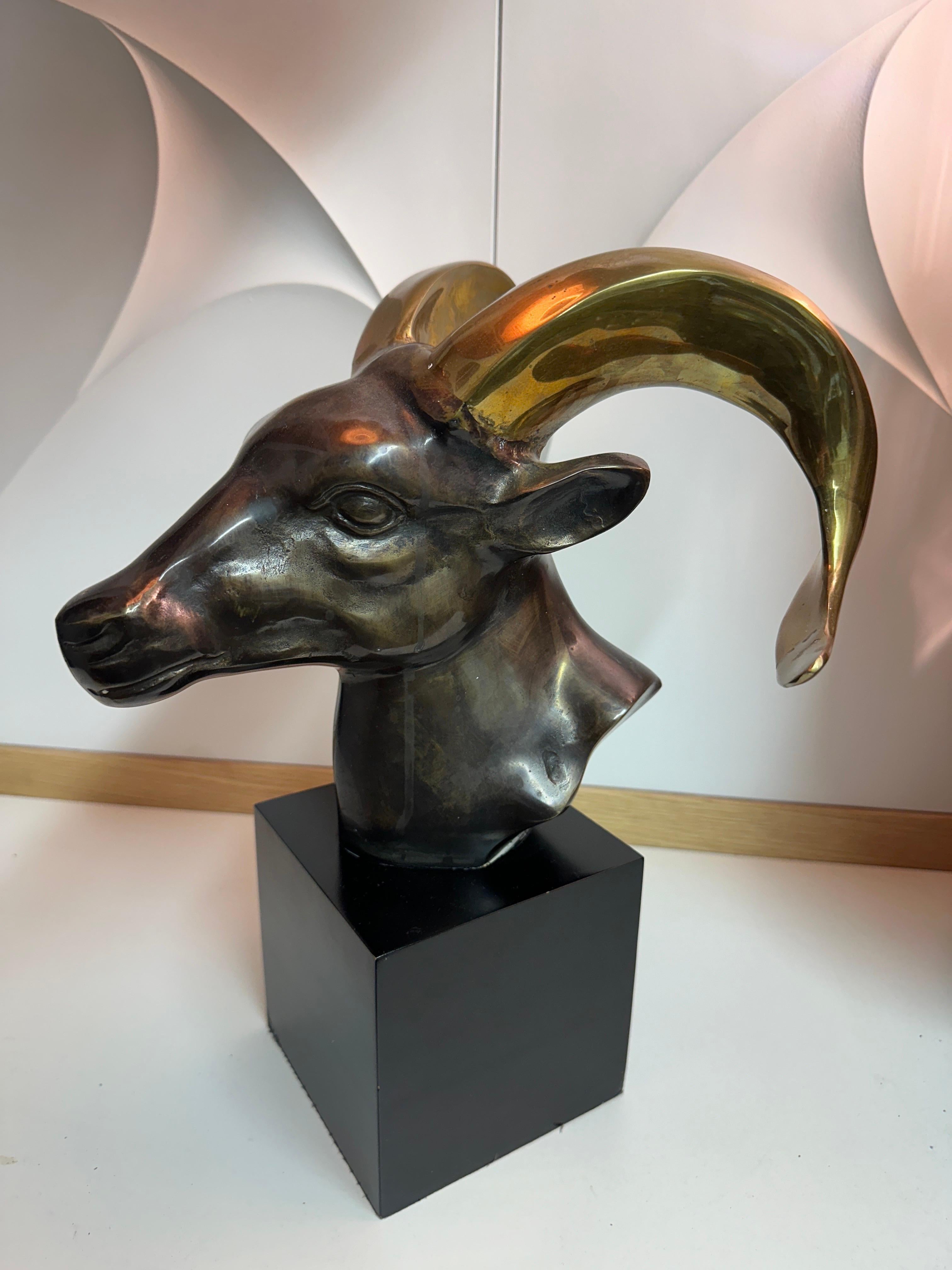 Two tone patinated brass ram / goat head sculpture on wooden base. Can also be used as a bookend. Base is 5