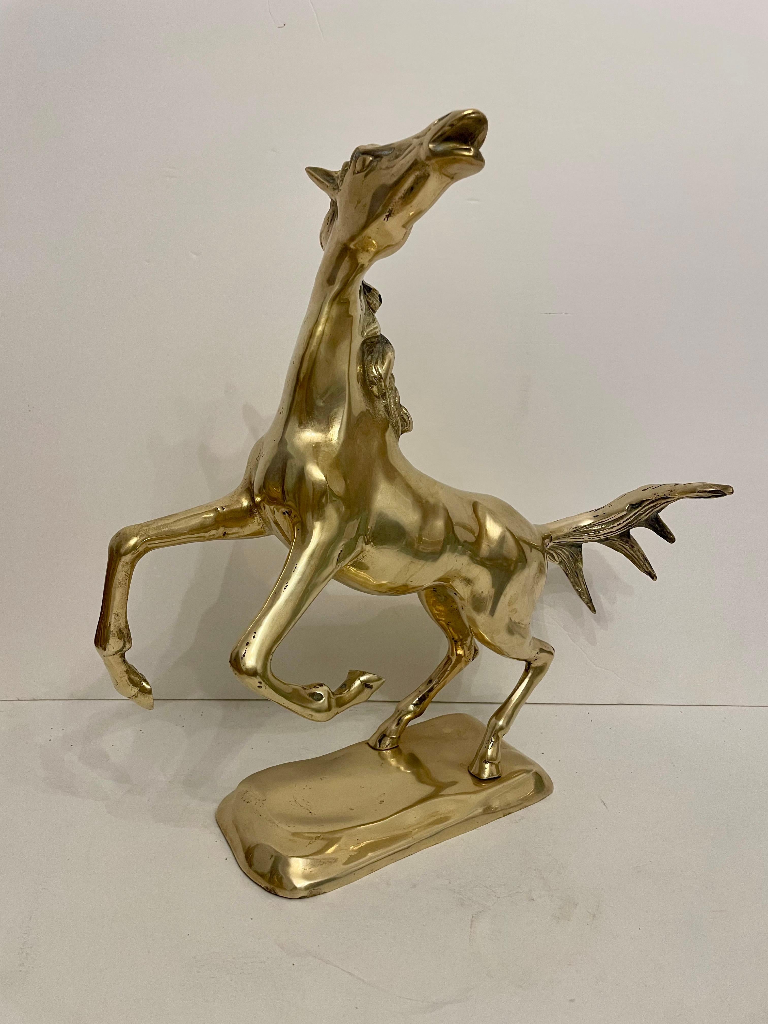 Brass Rearing Horse Sculpture Mounted on Brass Base. Nice detail in the casting. Good overall condition, hand polished. Light and dark spots are reflection only. Will look great on a mantel or shelf.