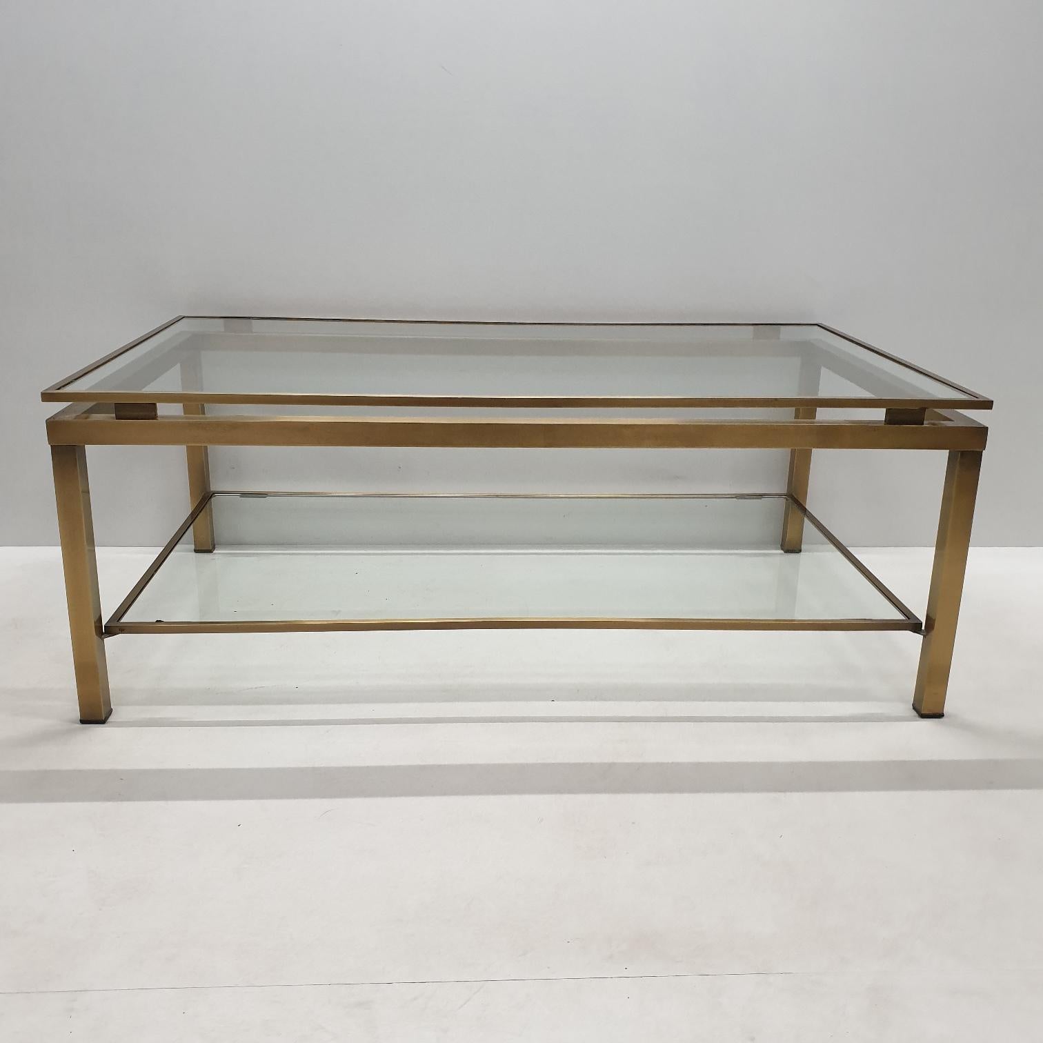 Vintage brass rectangular 2-tiers coffee table by Ben Demmers for BD Design, 1980s
handmade coffee table with 2 cut glass plates which are enclosed in the brass frames.
The table has a brushed brass frame.

In the style of Maison Jansen.