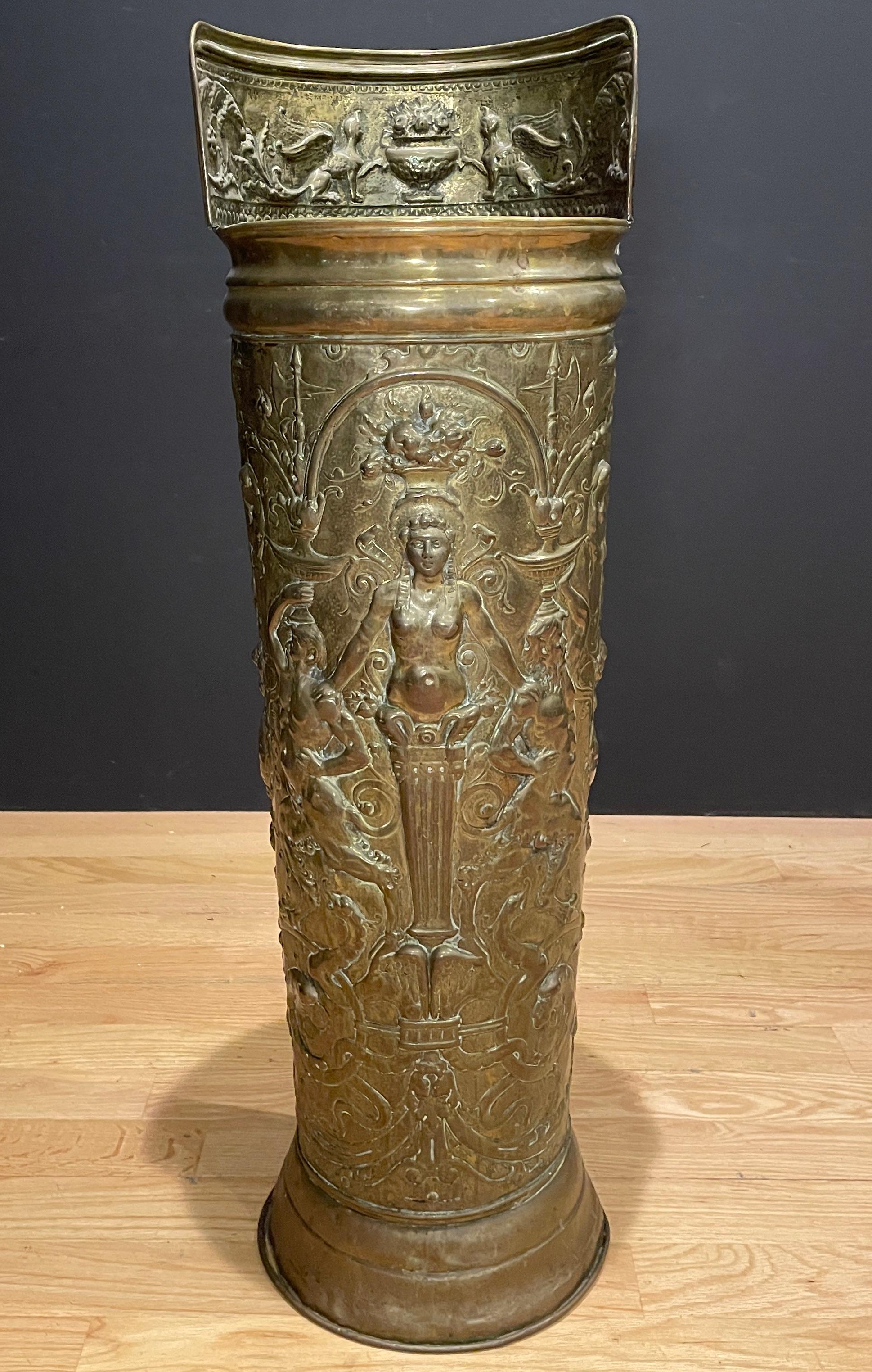 This versatile antique French repousse brass umbrella holder is one of the larger and more detailed models that we have found over the years. Its pronounced motifs have been done in relief and include a Caryatid surrounded by scrolling rinceau and