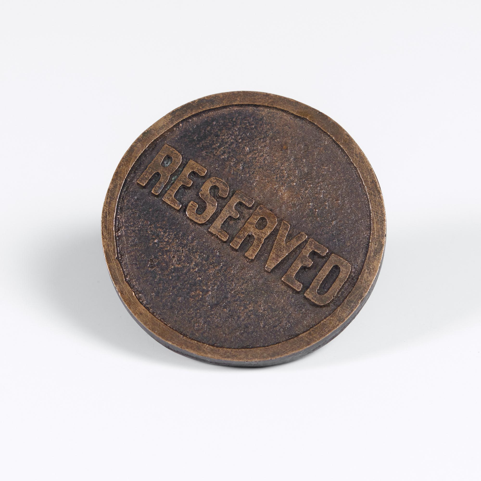 Brass decorative object or paperweight. This brass button showcases a round face with embossed 