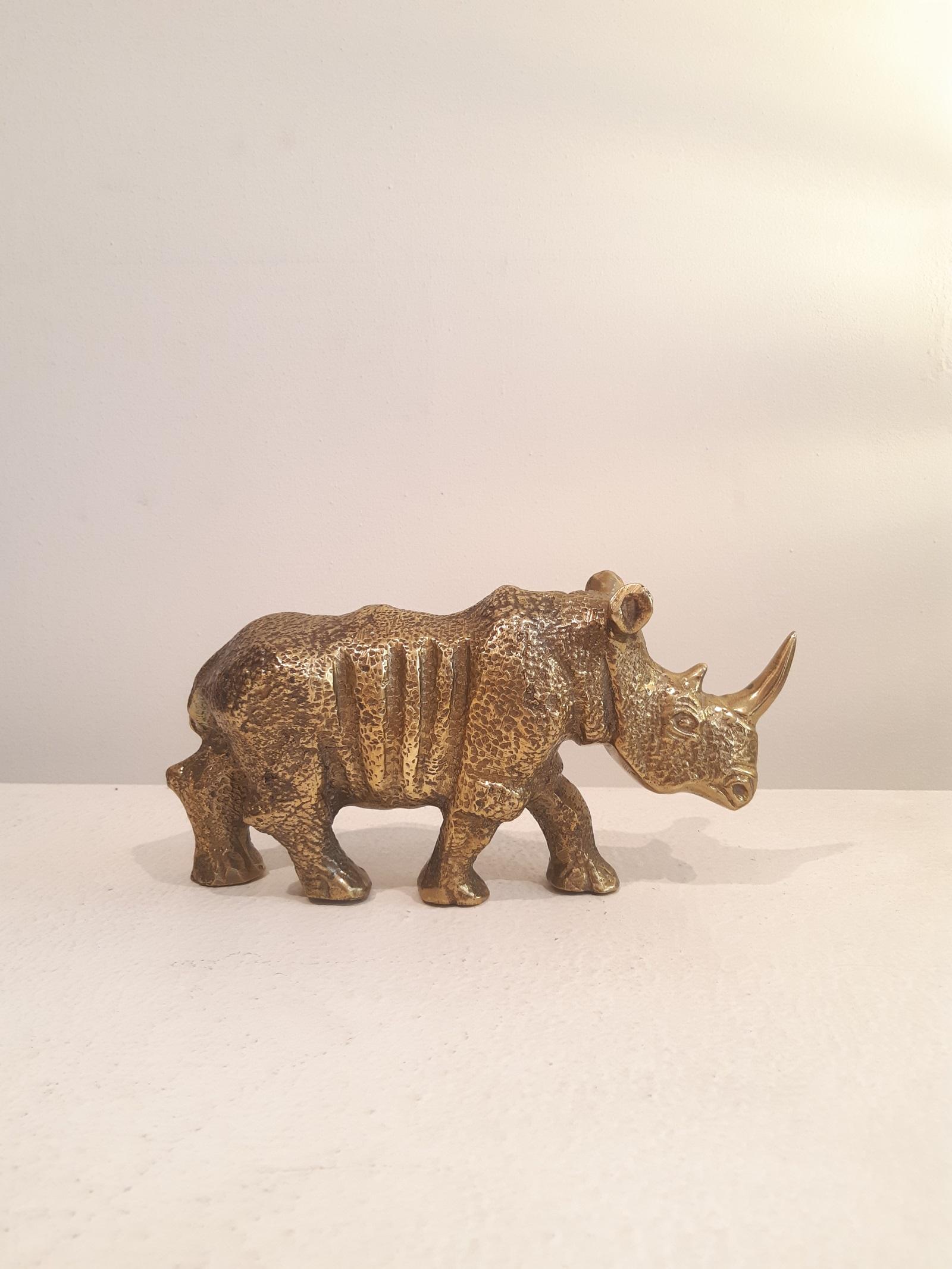 Brass Rhinoceros figurine 1970s Mid-Century Modern sculpture 
Measures: Depth 23cm, width 6cm, height 11cm. Weight 4kg
Good condition.