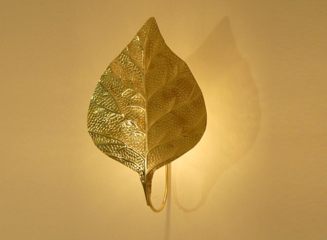 Italian wall light featuring an unlacquered natural brass shade in the shape of a large rhubarb leaf / Made in Italy in the style of Tommaso Barbi
Measures: Height 23 inches, width 15.5 inches 
1 light / E12 or E14 type / max 40W
Order Only / This