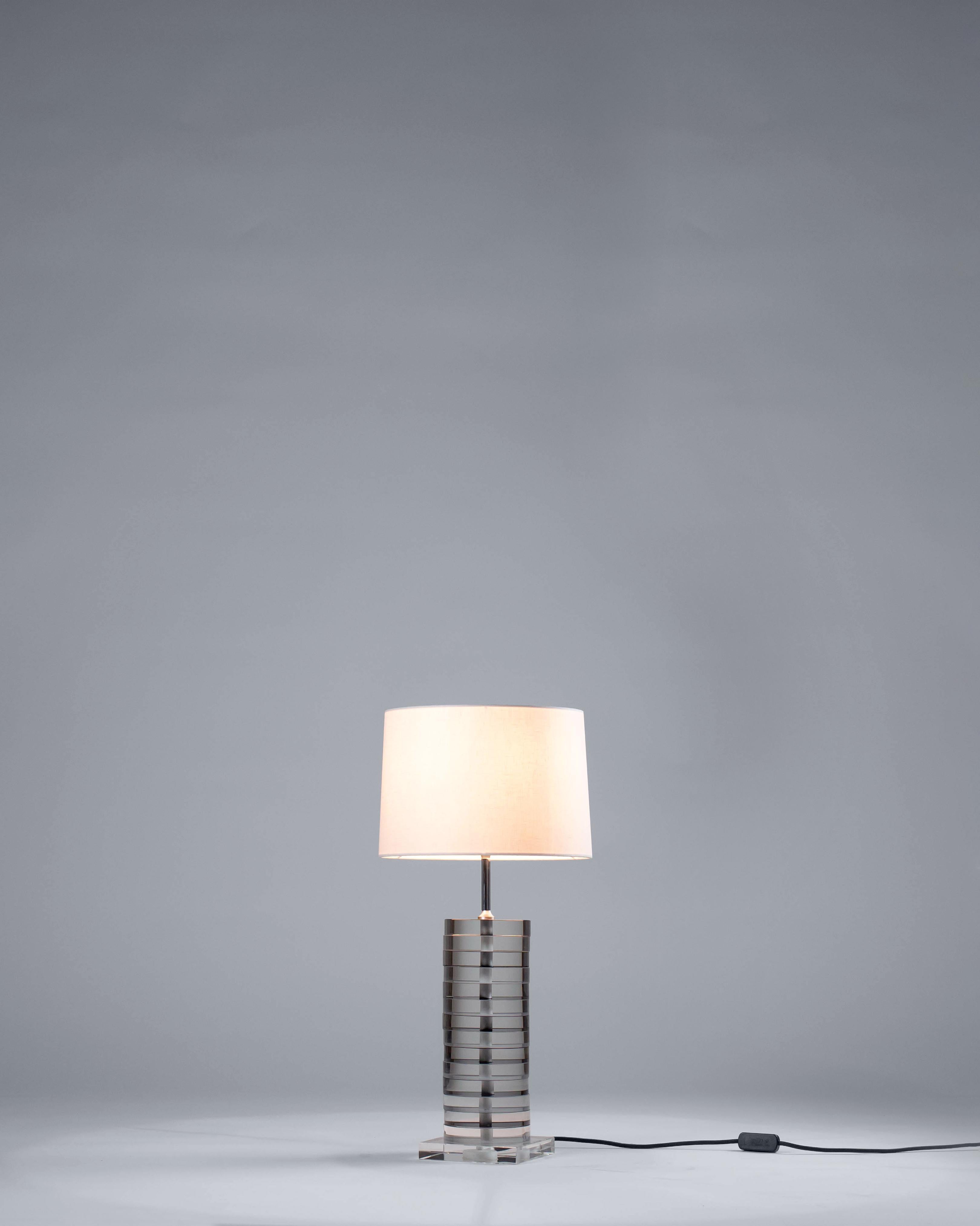 Brass Ring Table Lamp by G.Luce
Dimensions: W 40 x D 40 x H 36.7 cm
Materials: Circular Sections of Black and White Crystal Rings, Internal Polished Chrome Structure. 
Weight: 12.5 Kg. 

G.Luce is the result of a thirty-year history of commitment,