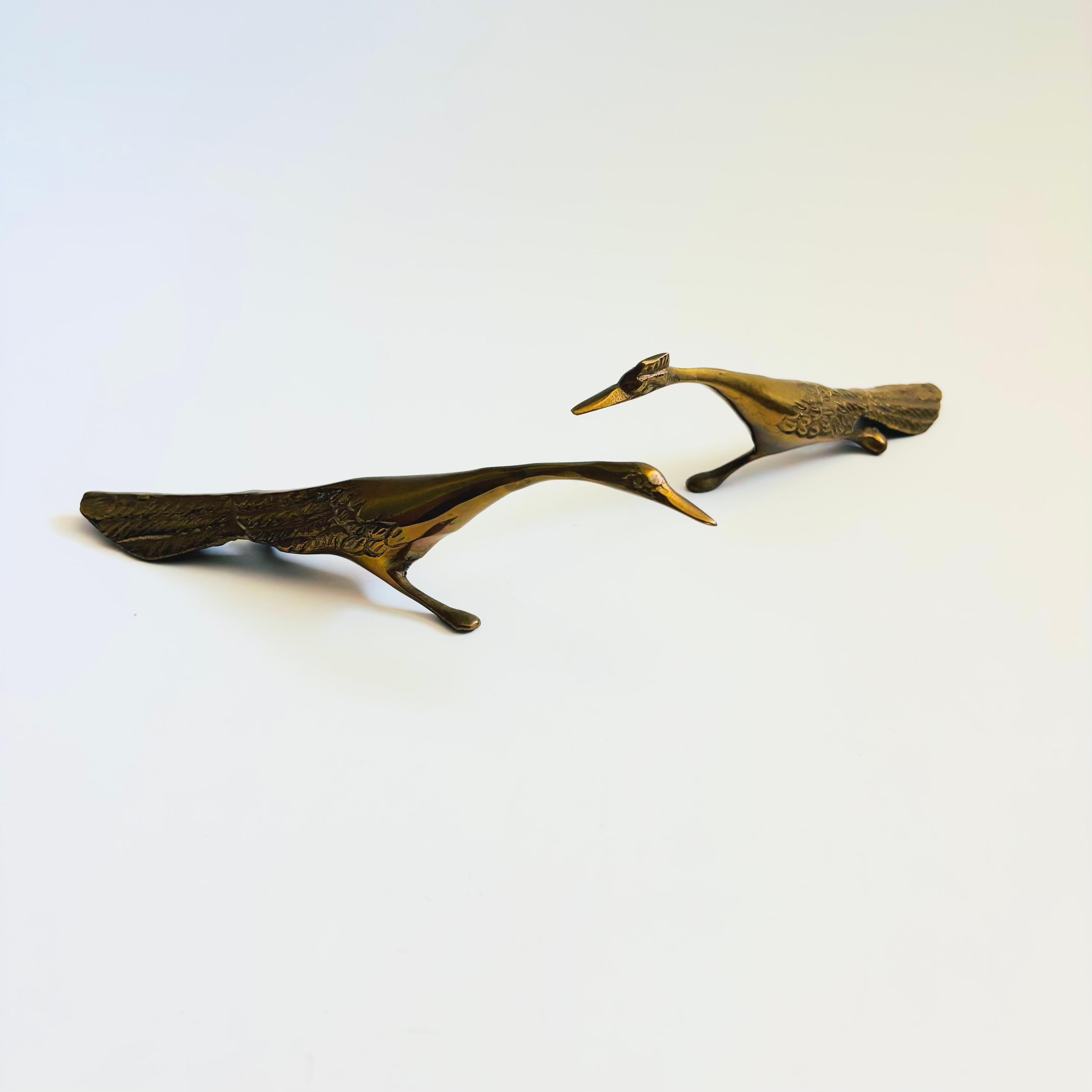 A pair of vintage brass roadrunners - a female and a male. Unique stylized design. Great detailing has been formed into the brass to create the birds features.

